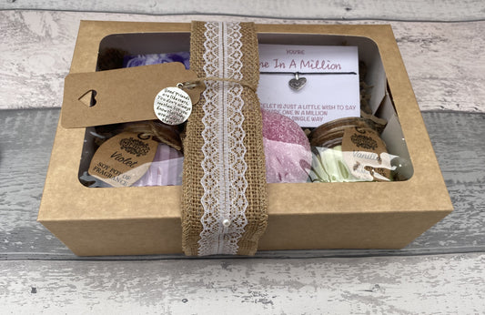 Gift box with lace ribbon on a wooden surface