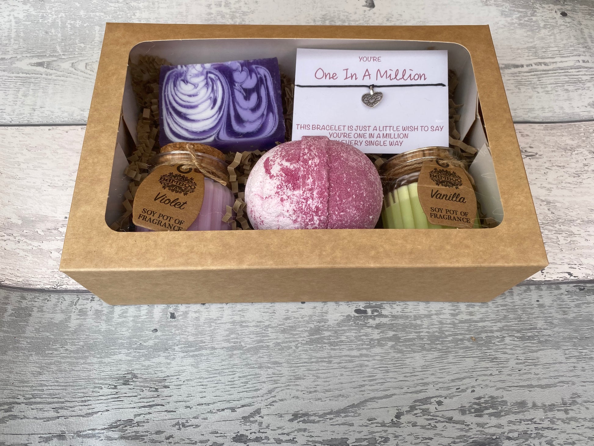 Gift set with bath bombs and soaps in a box on a wooden surface