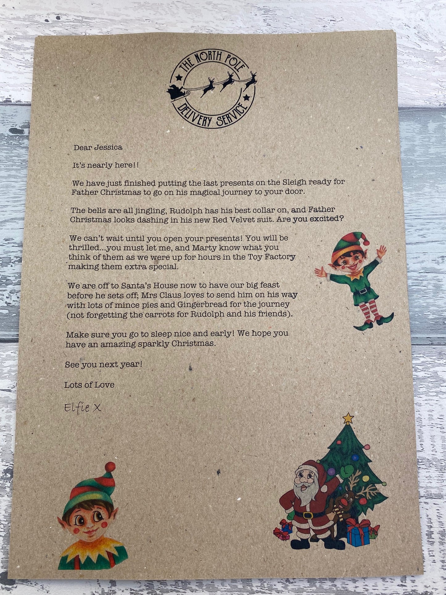 Kraft paper envelope with Christmas-themed illustrations and text on a wooden surface