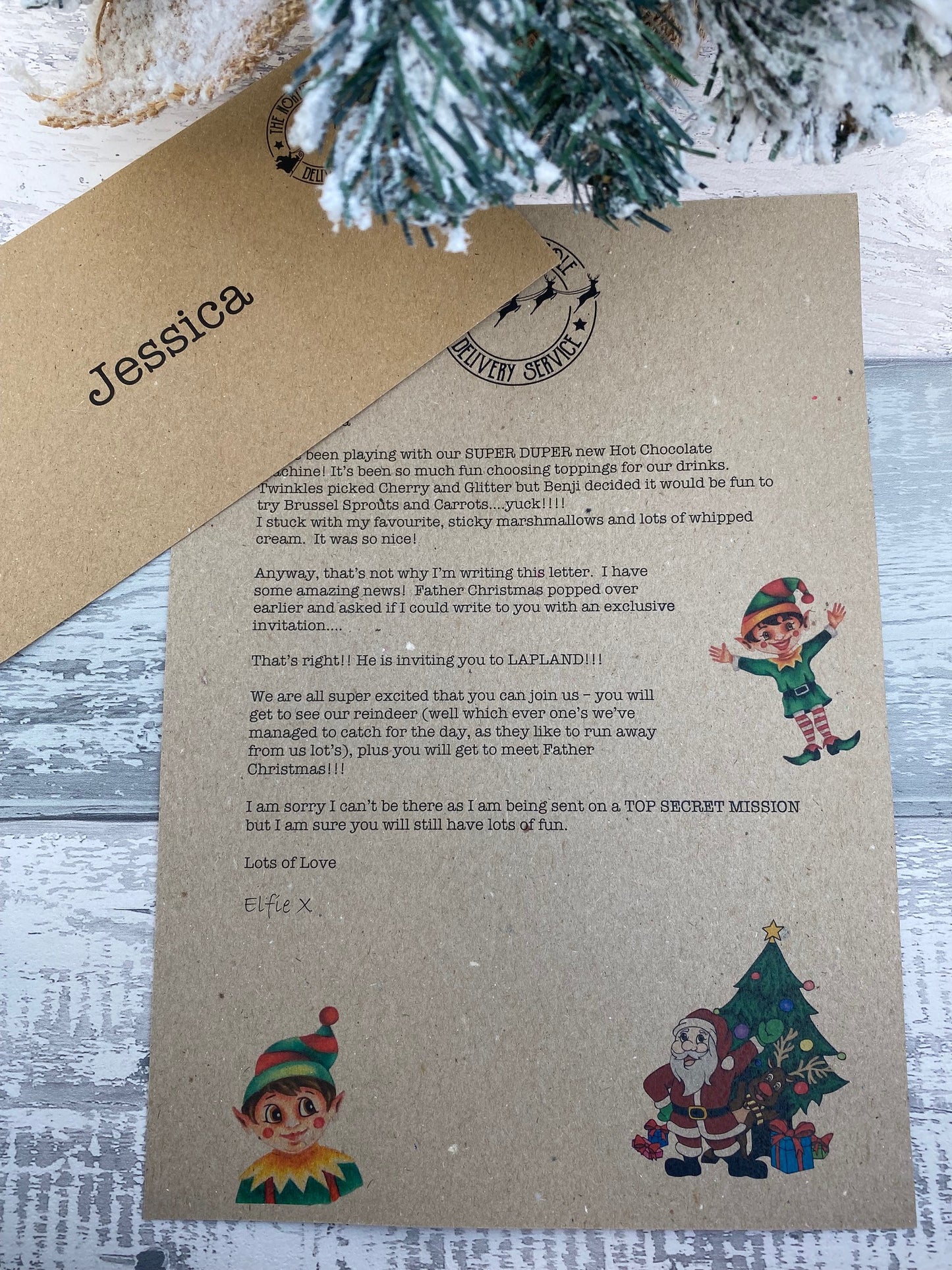 Letter on kraft paper with Christmas-themed illustrations and text, placed on a wooden surface.