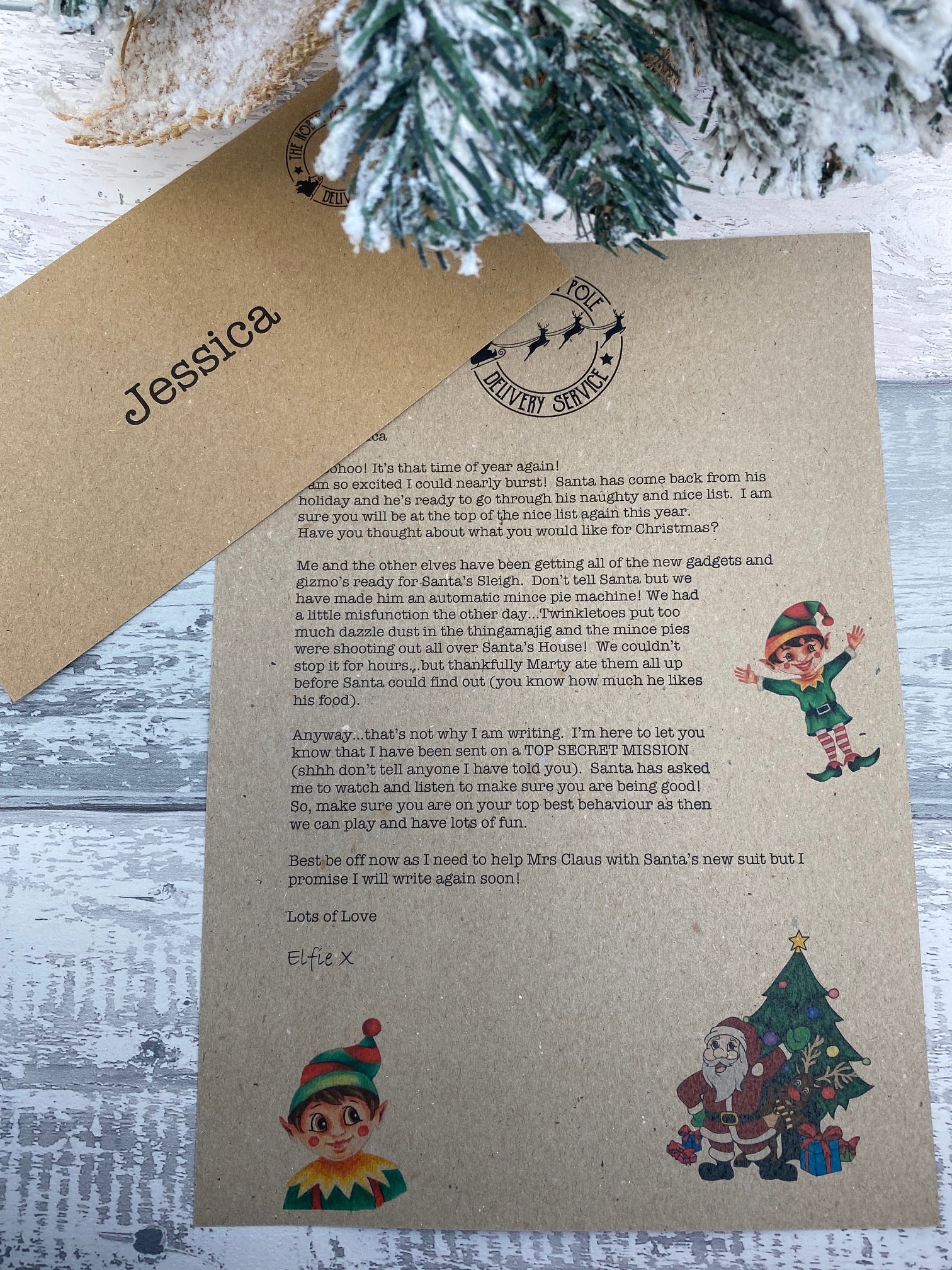 Personalised Xmas Letter on kraft paper with Christmas-themed illustrations and text, placed on a textured surface.