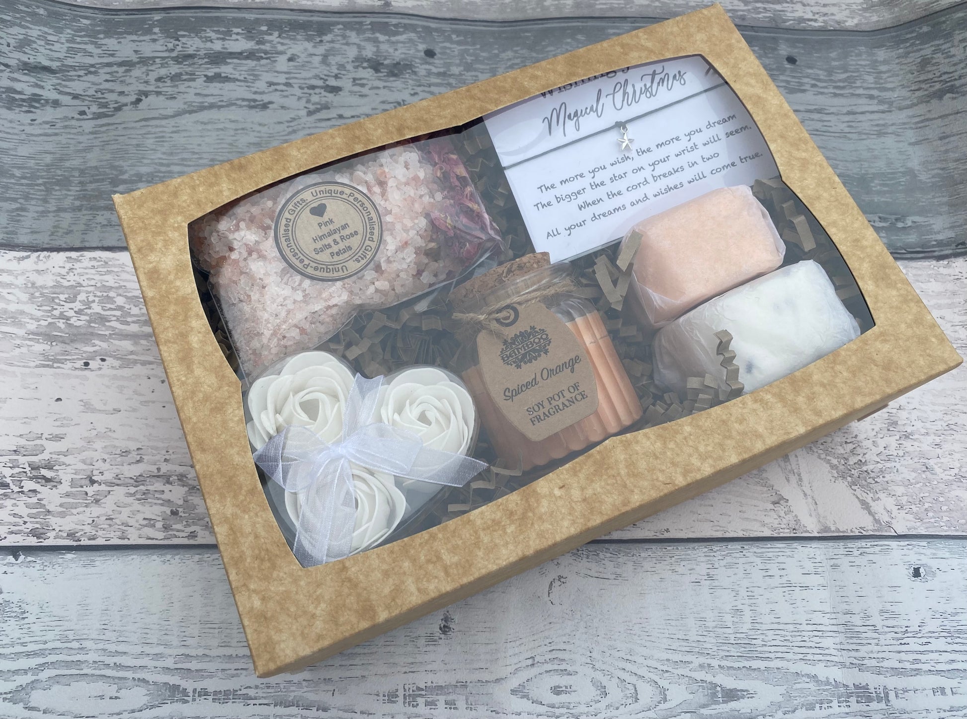 Gift set with bath products in a cardboard box on a wooden surface