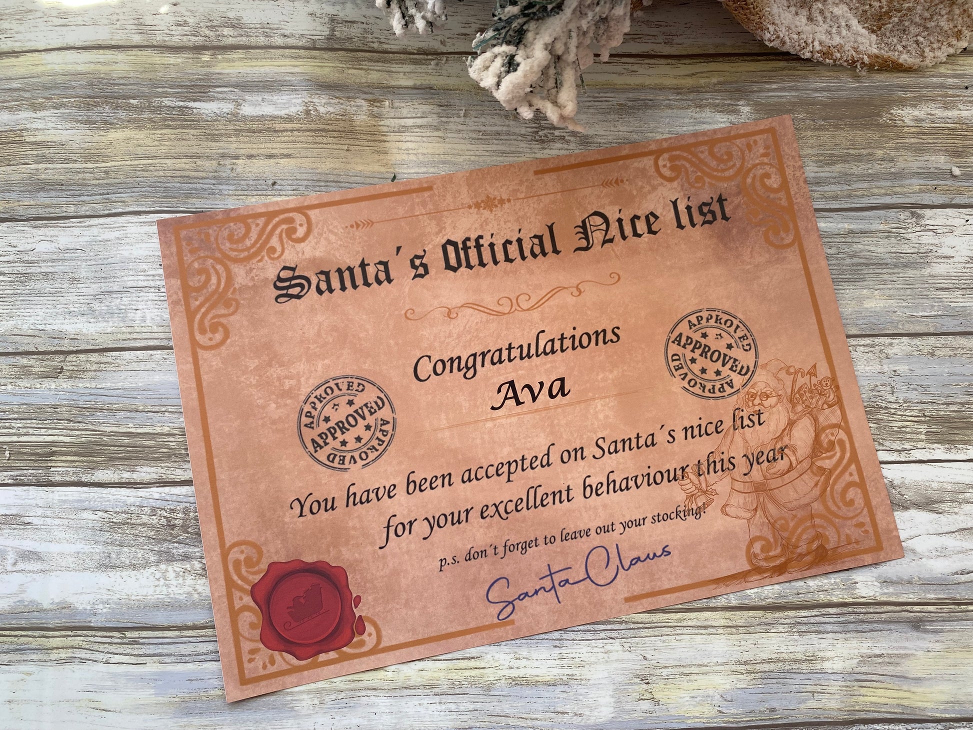 Certificate on a wooden surface with 'Santa's Official Nice List' text