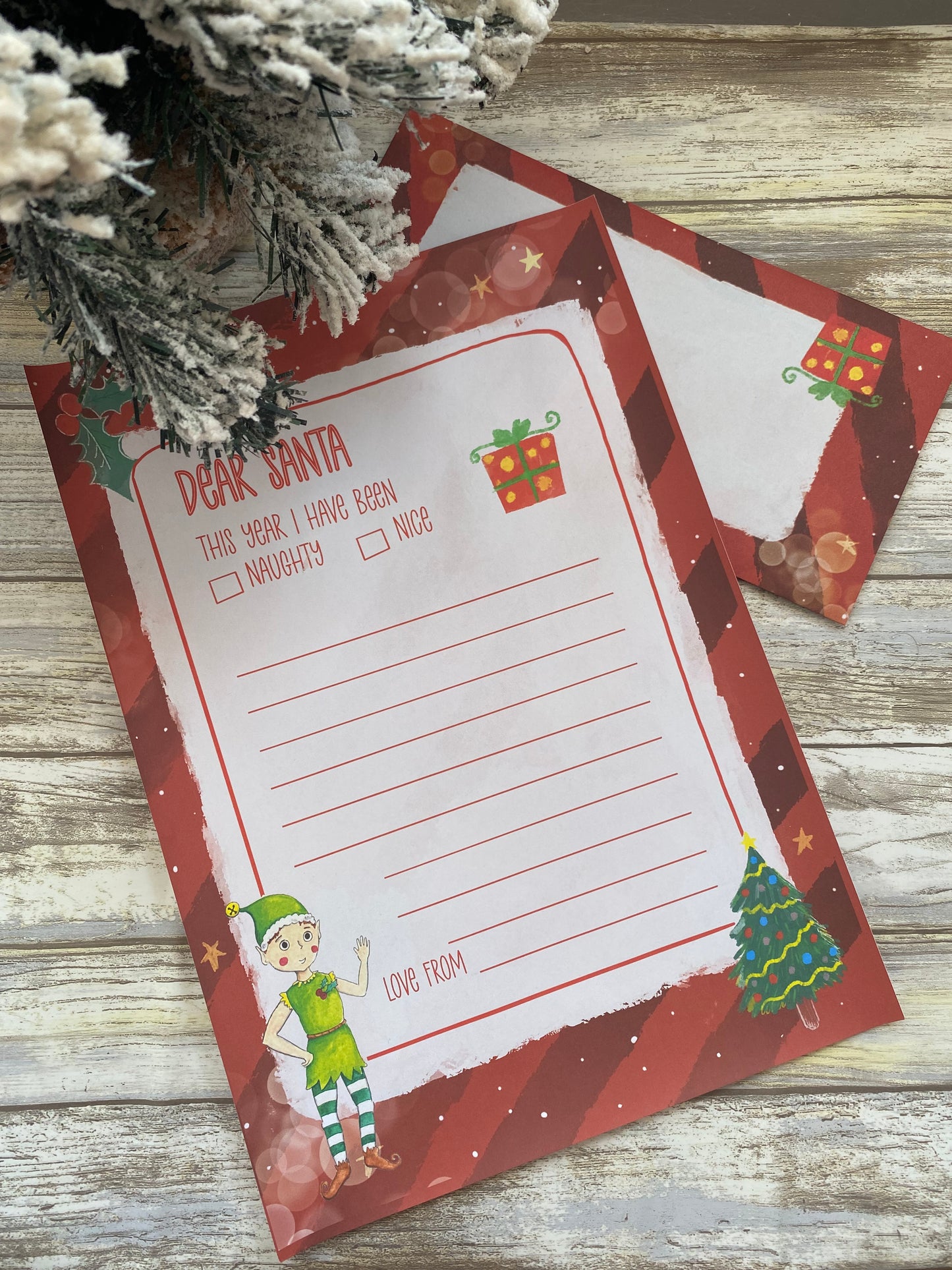 Christmas-themed letter to Santa Claus on a wooden surface with decorative elements.