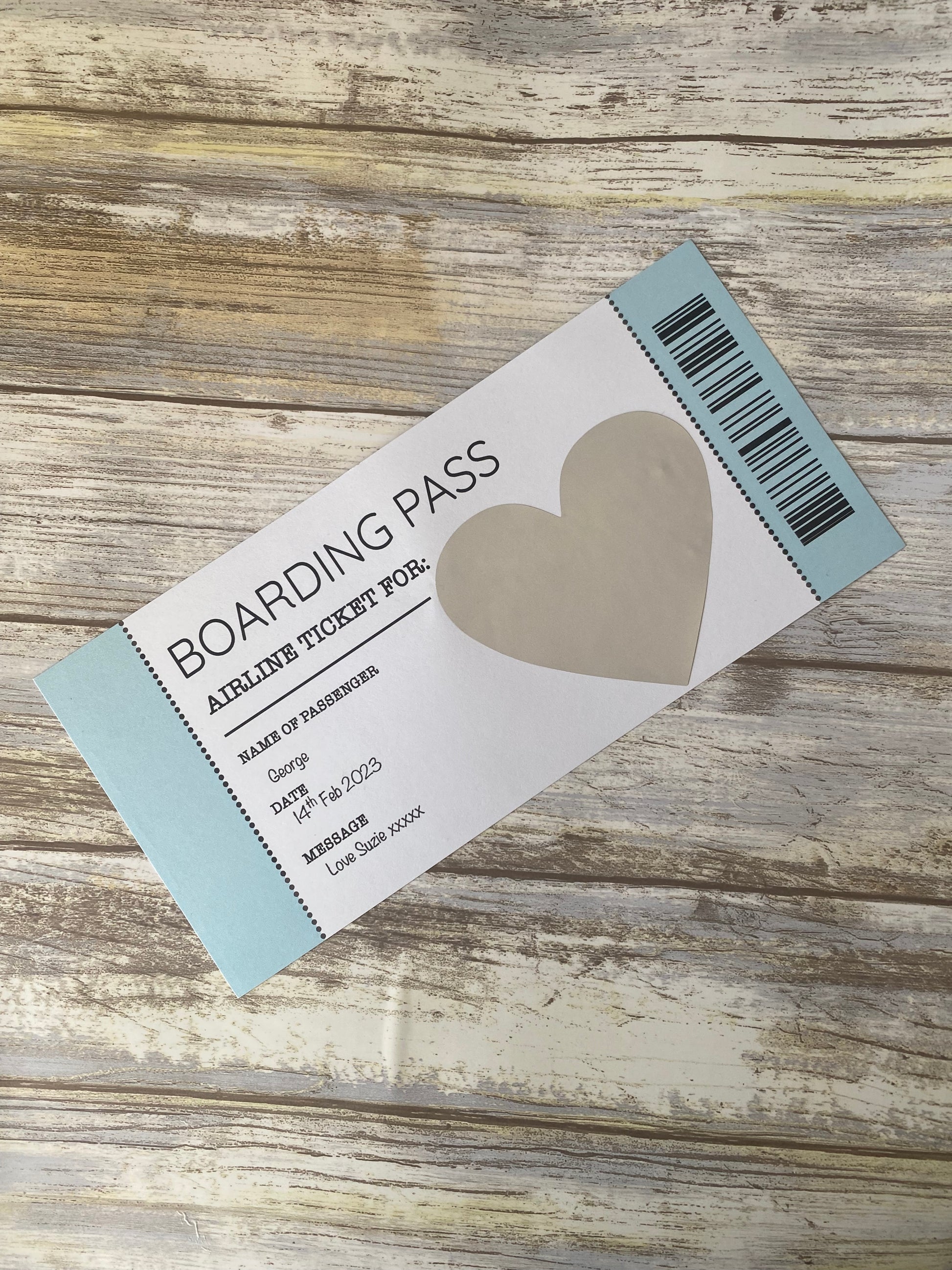 Boarding pass with heart design on a wooden surface