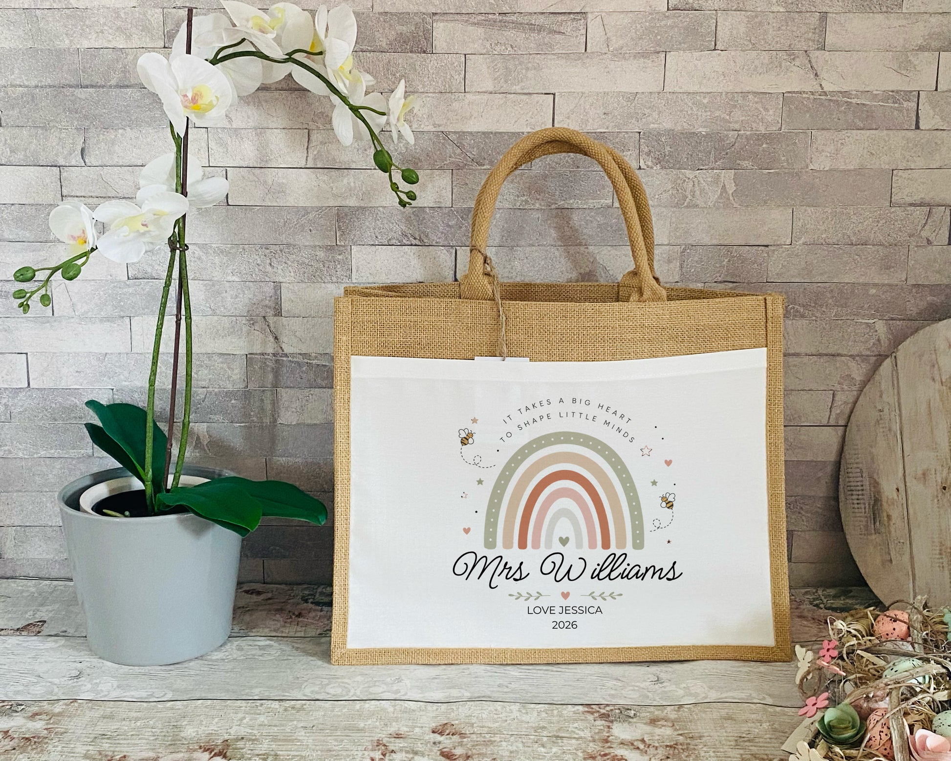 Personalised Teacher tote bag with rainbow and Bee design and text on a wooden surface
