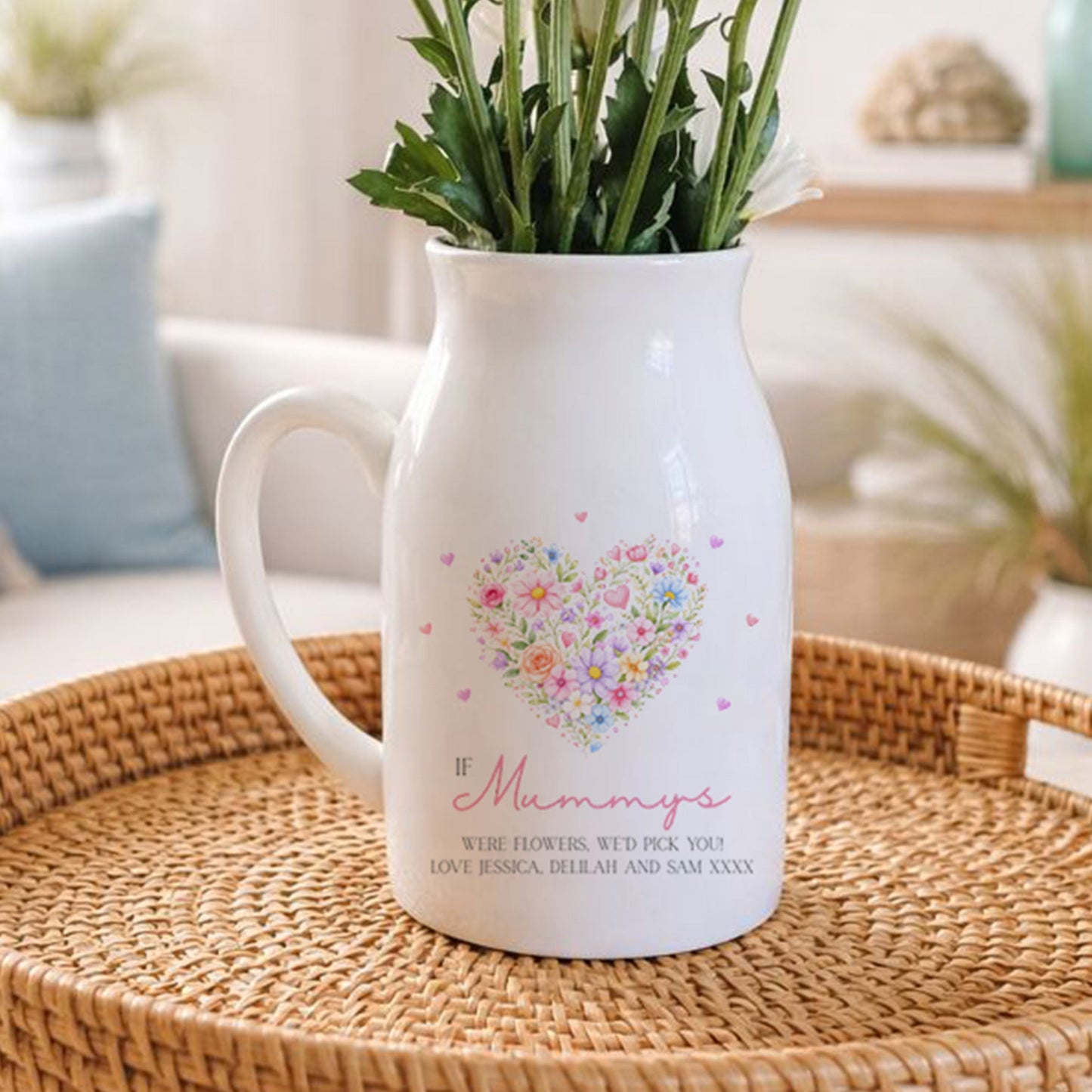 White vase with floral design and text on a woven tray