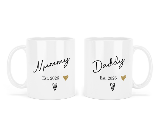 Two personalised white mugs with 'Mummy Est. 2026' and 'Daddy Est. 2026' text on a white background