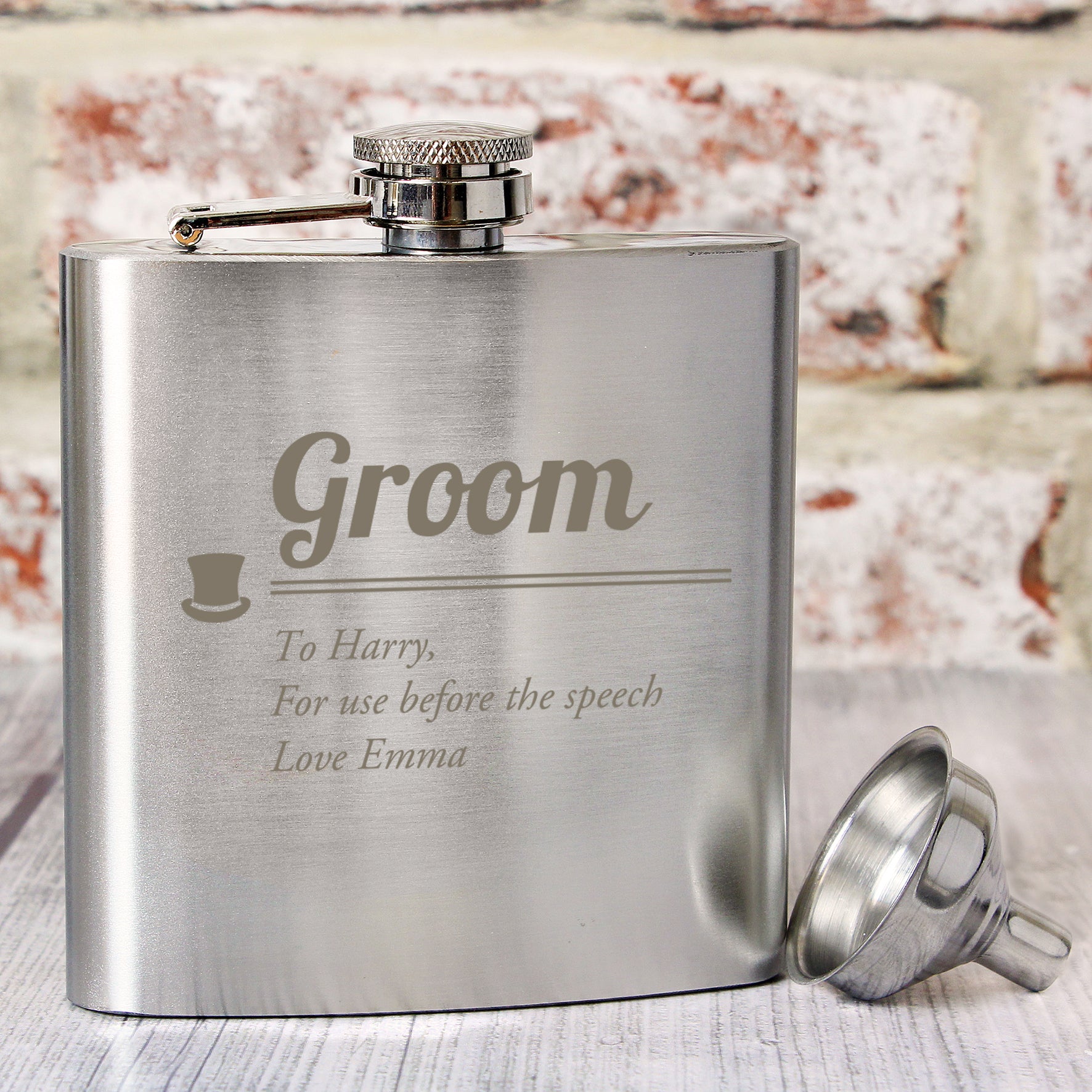 Stainless steel flask engraved with 'Groom' and personalised text, on a wooden surface.