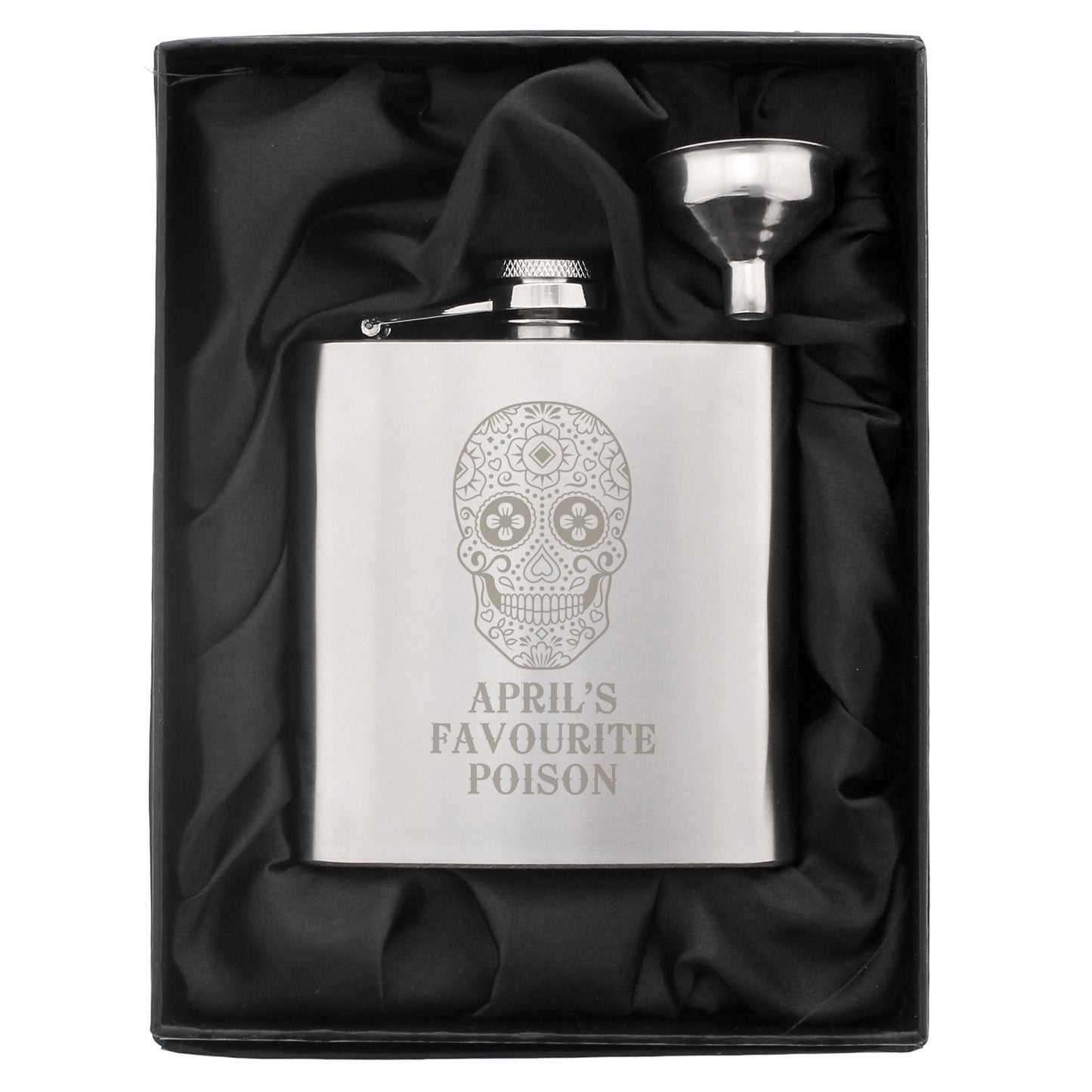 Silver flask with skull design and 'April's Favourite Poison' text in a black satin-lined box.