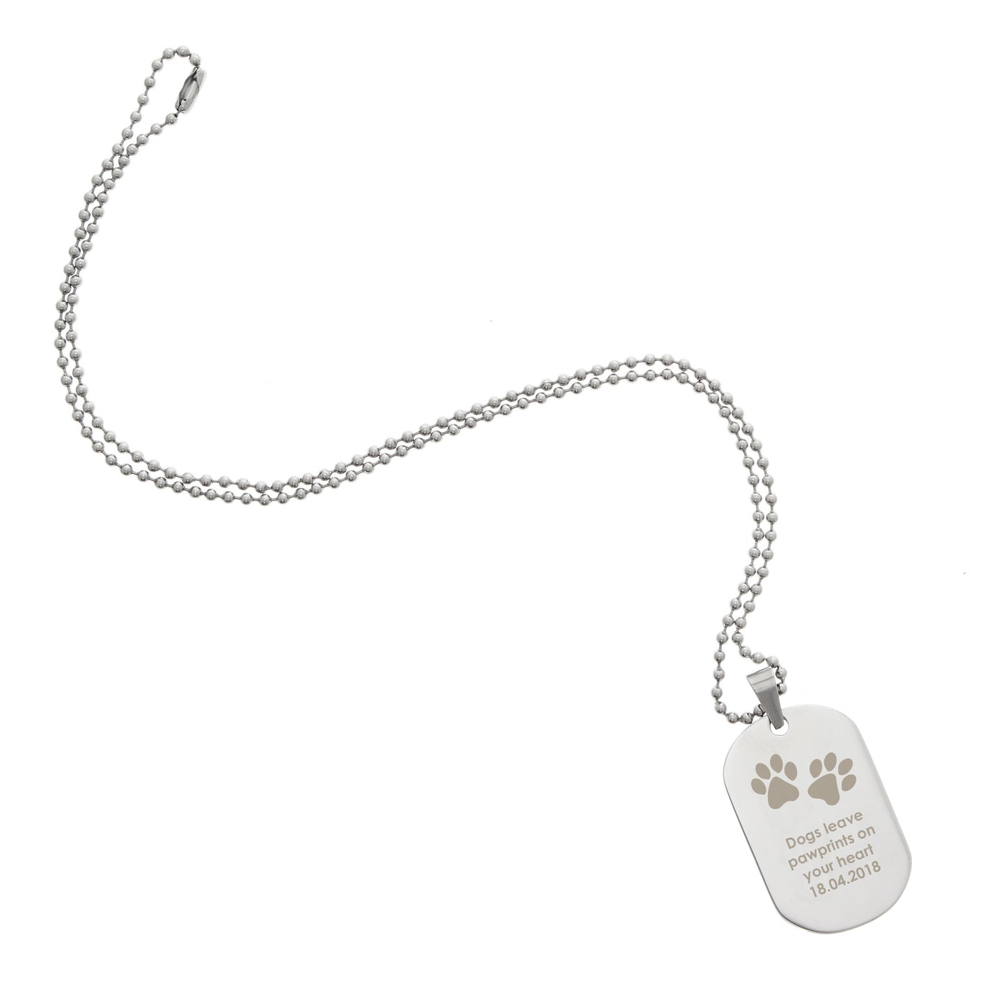 Silver dog tag with paw prints on a white background