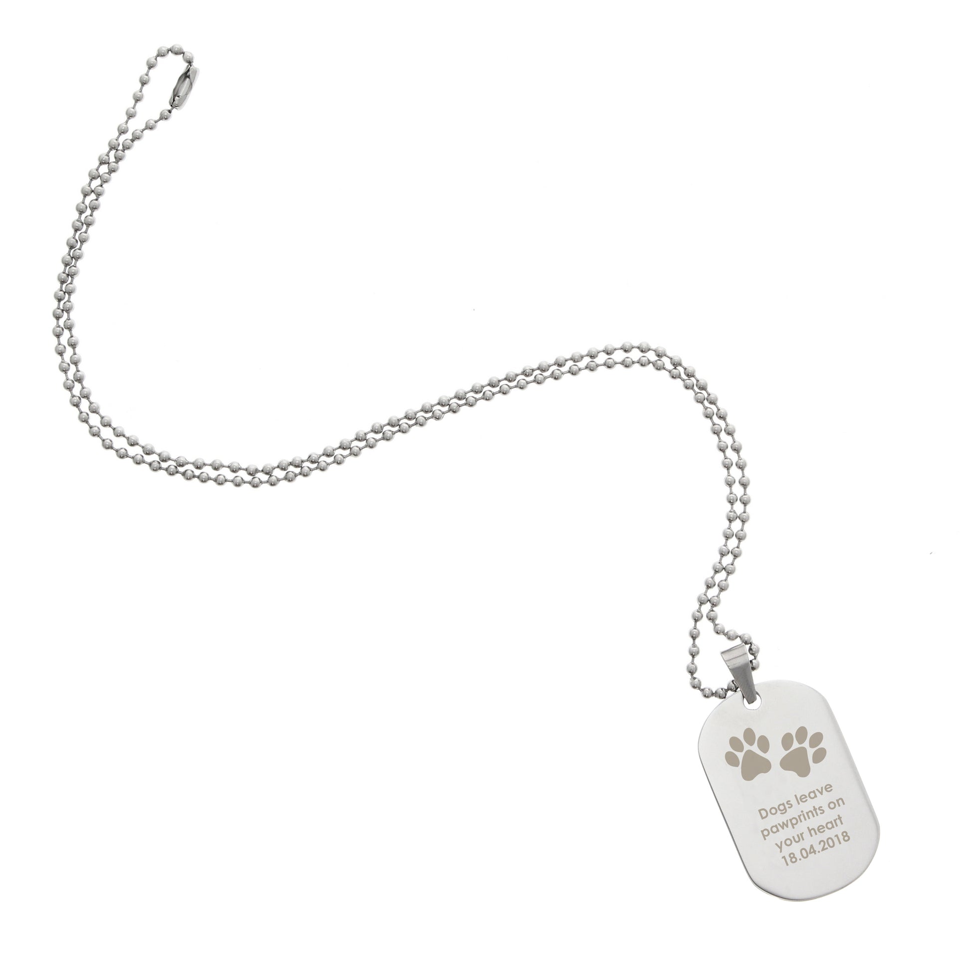 Silver dog tag with paw prints on a white background