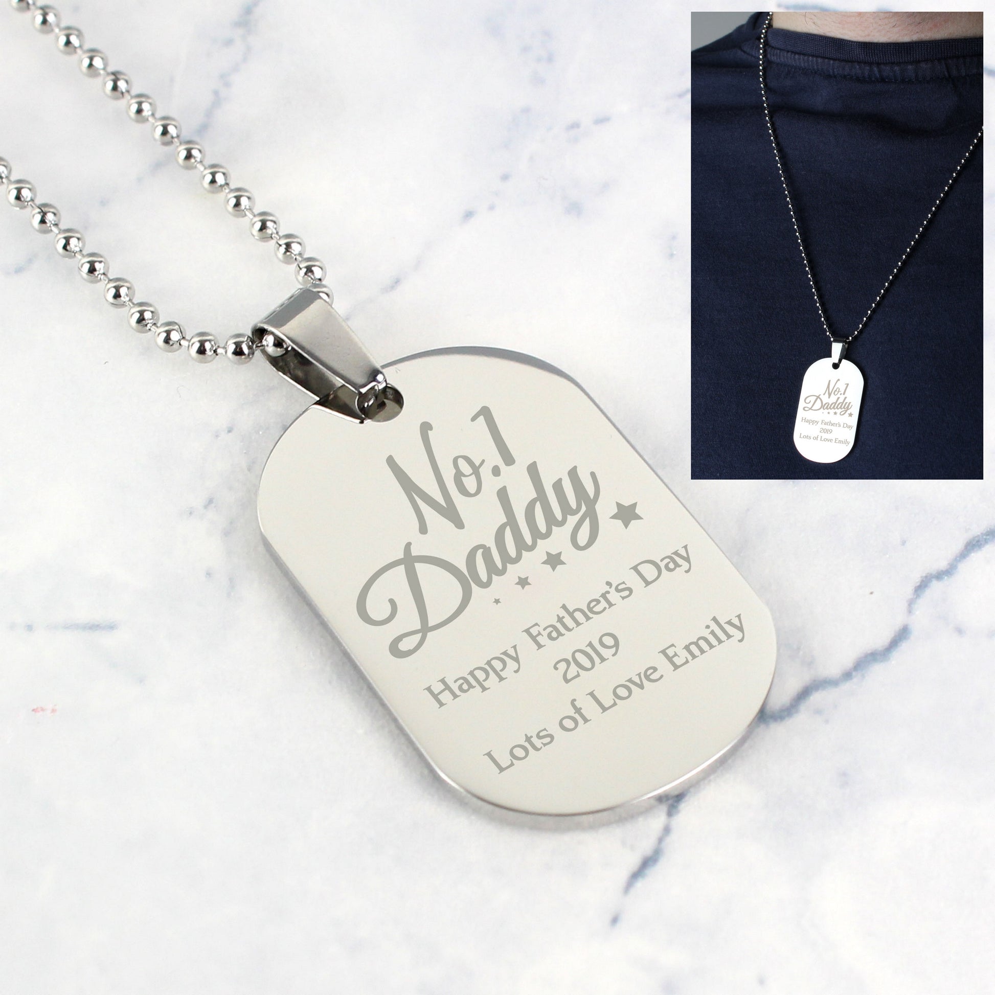 Dog tag necklace with engraved text on a marble surface