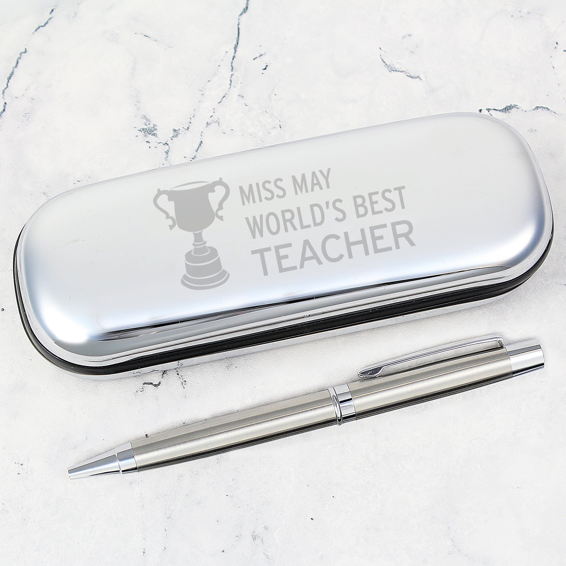 Personalised Silver pen case with engraved text and a silver pen on a marble surface