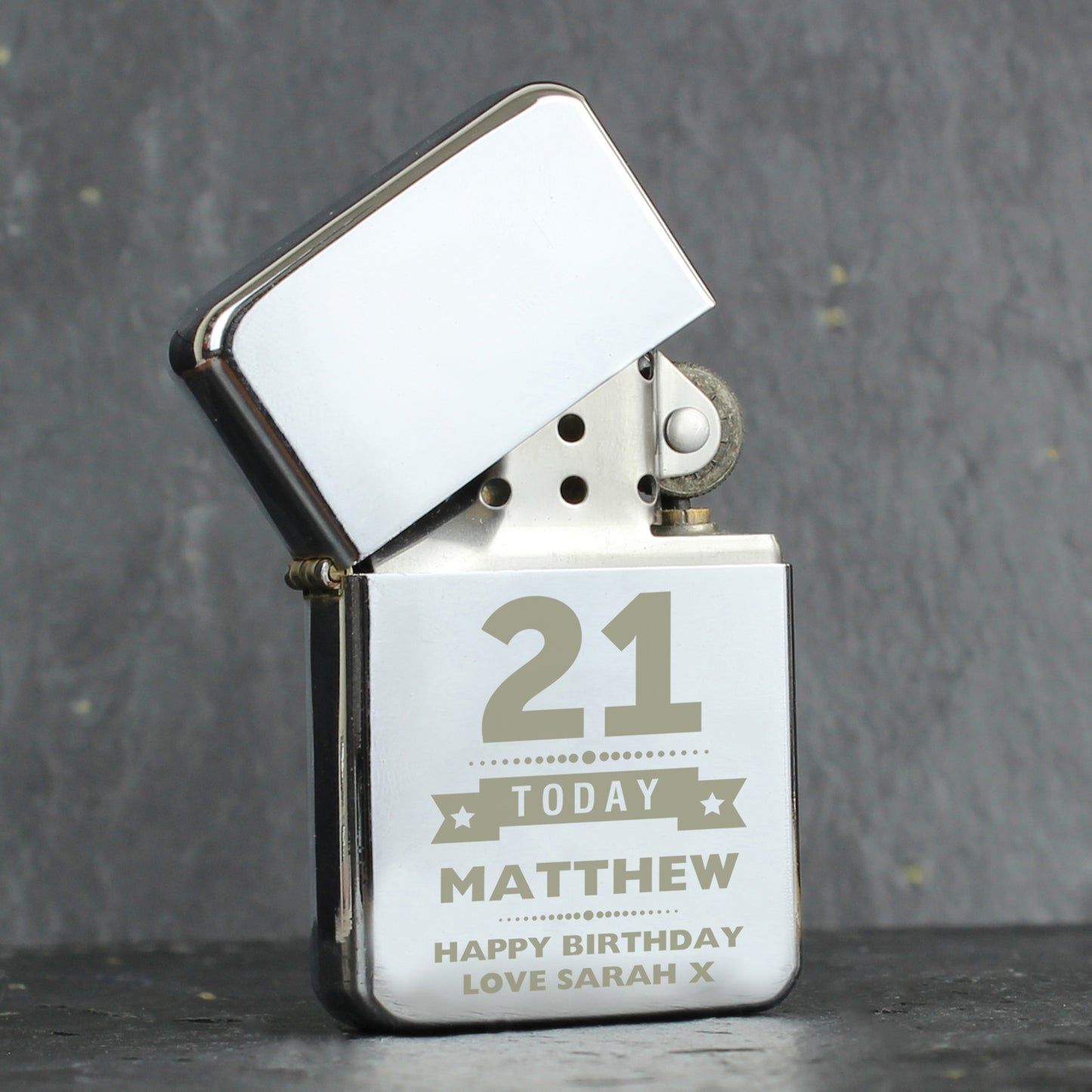 Personalised lighter with engraved text on a grey background