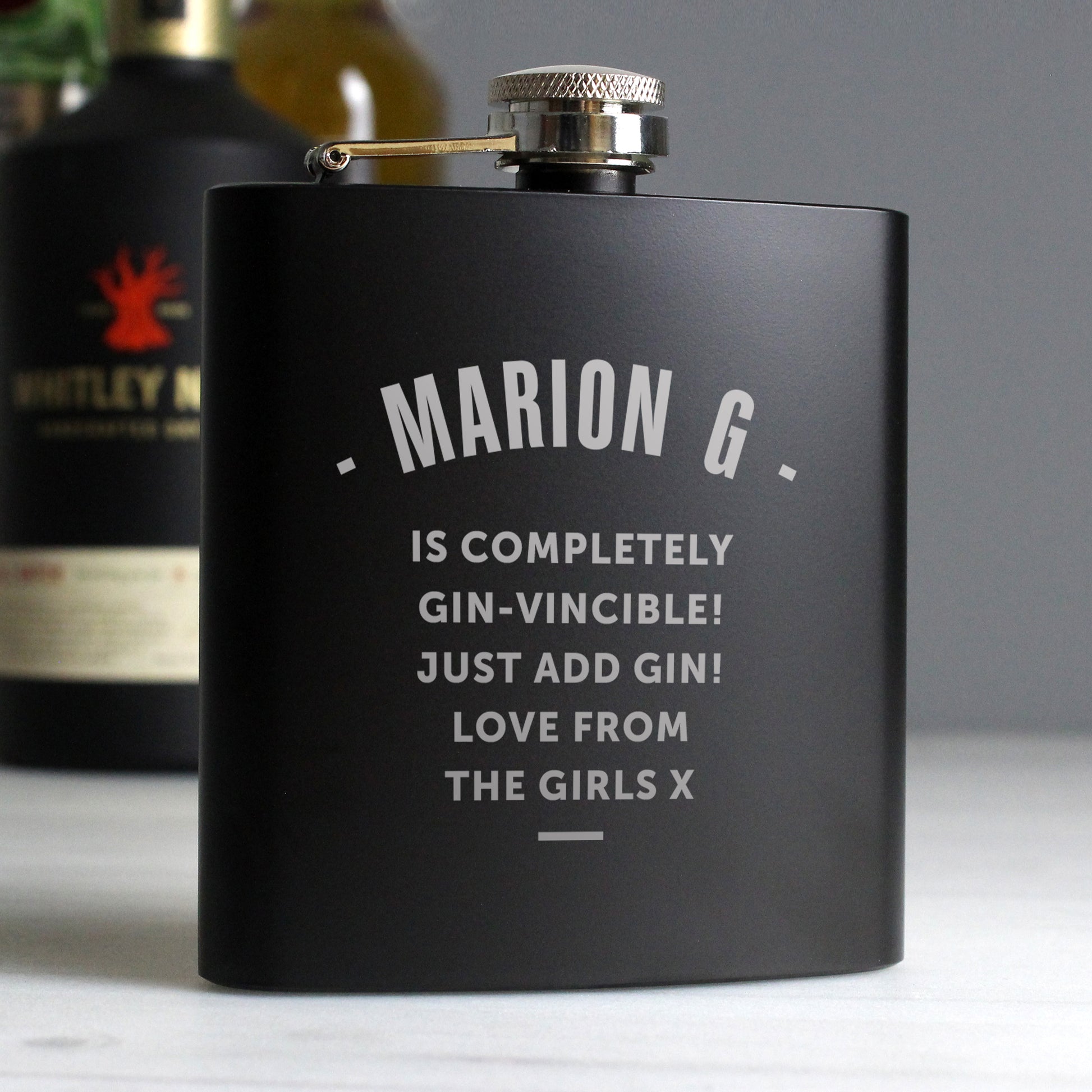 Black flask with humorous text on a grey background