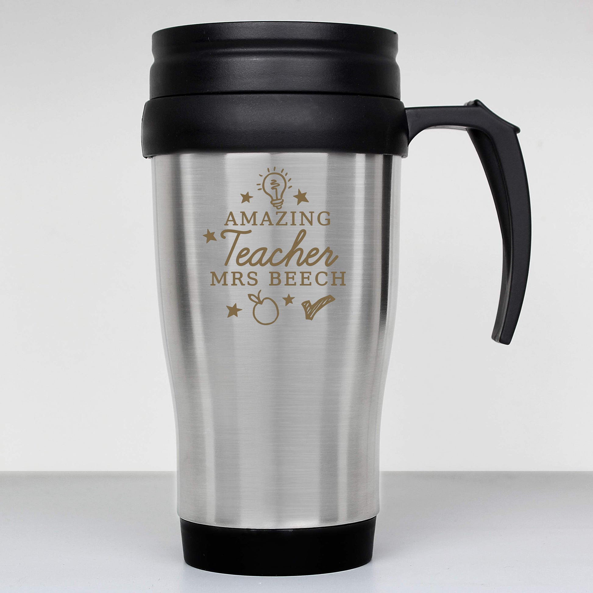 Stainless steel travel mug with black handle and engraved text on a white background