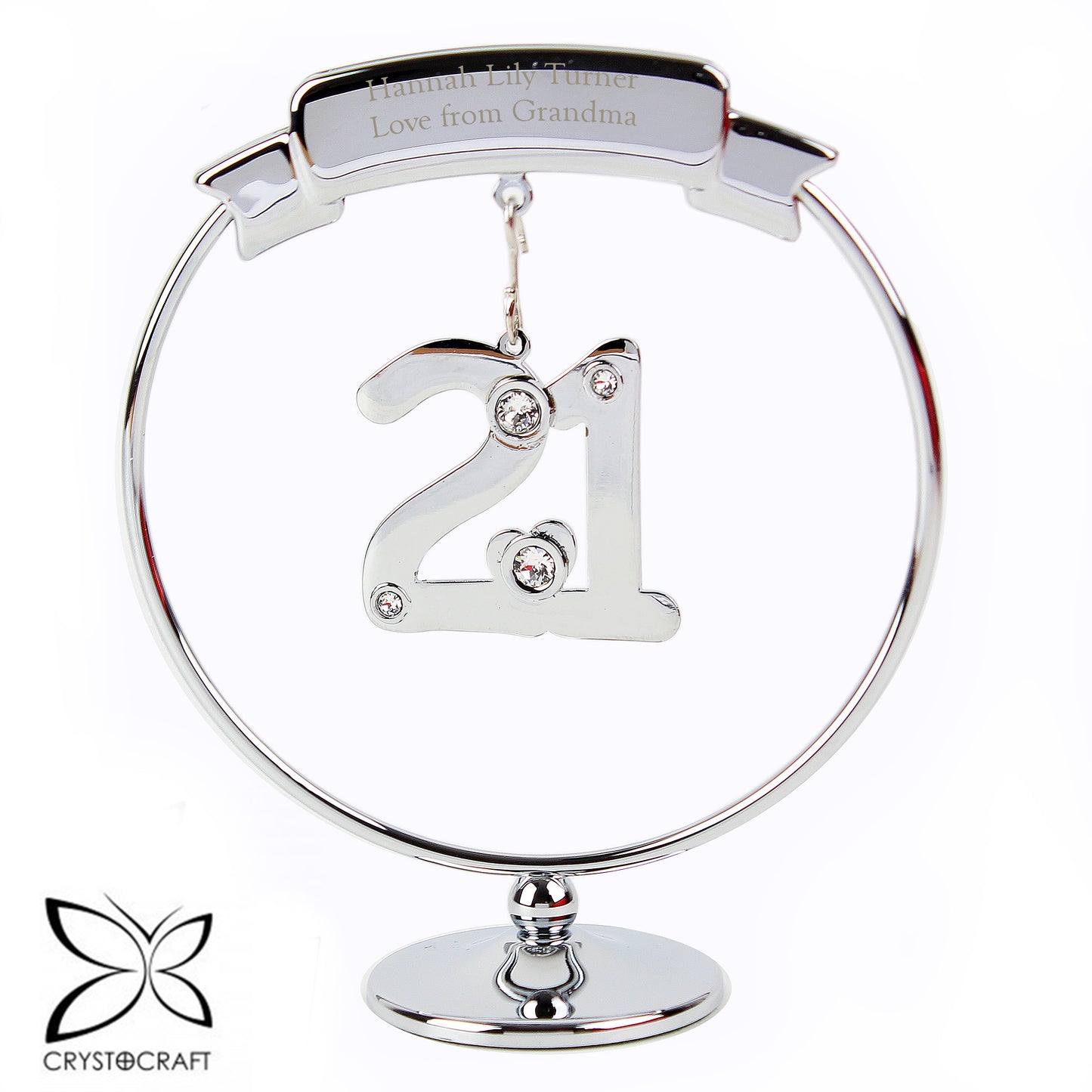 Silver ornament with '21' and engraved text on a white background