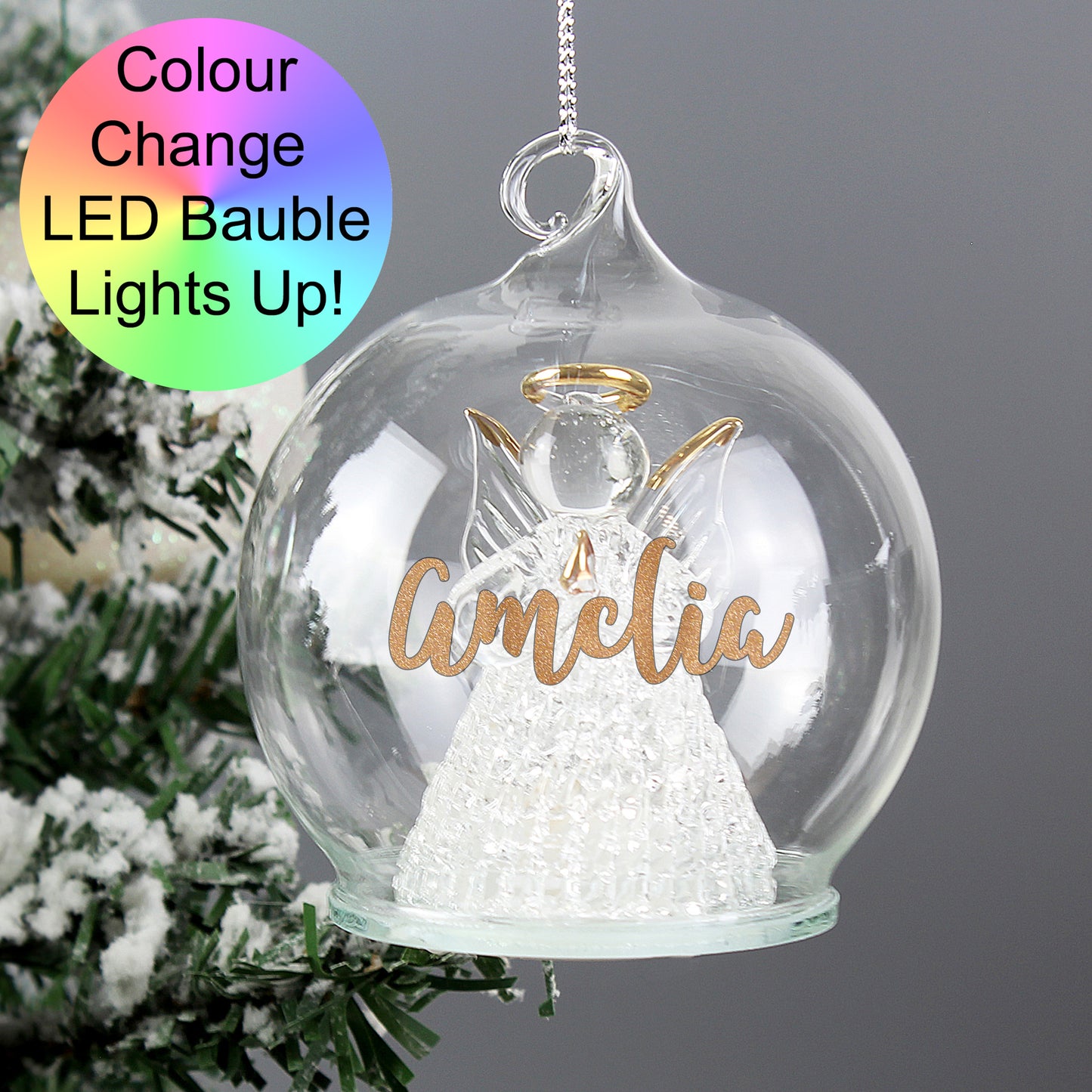Decorative angel ornament in a glass sphere with 'Amelia' on it, featuring LED lighting.