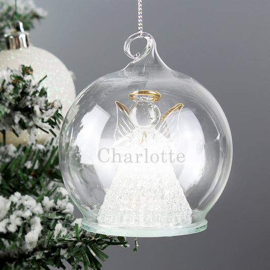 Glass ornament with an angel inside, personalized with 'Charlotte', on a Christmas tree.