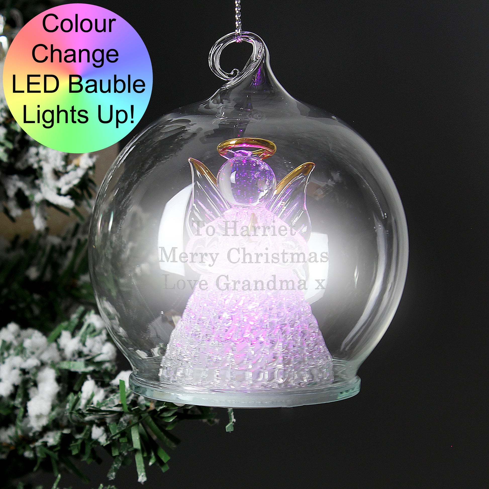 Color-changing LED bauble with angel design on a Christmas tree.