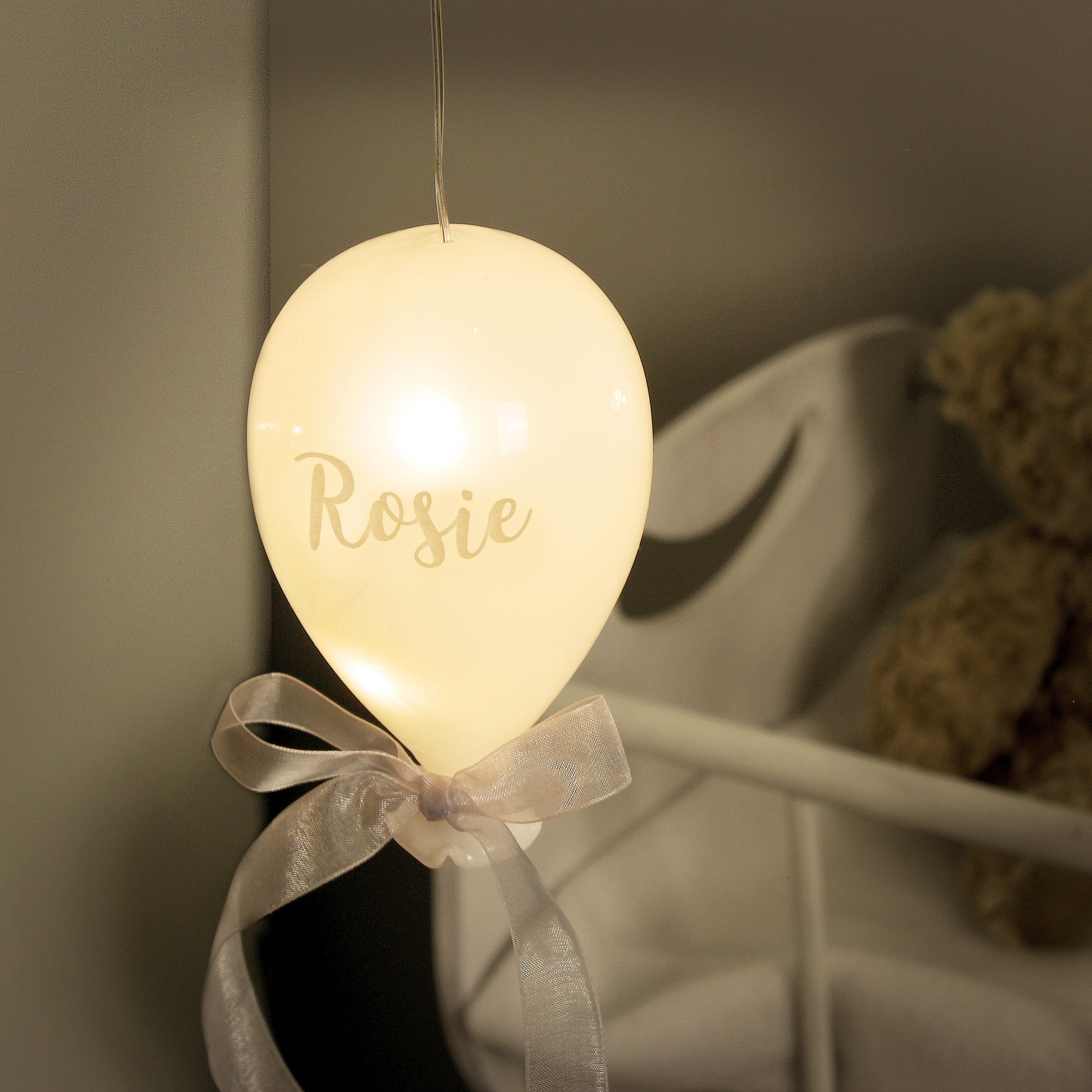 Decorative light shaped like a balloon with 'Rosie' written on it, hanging against a neutral background.