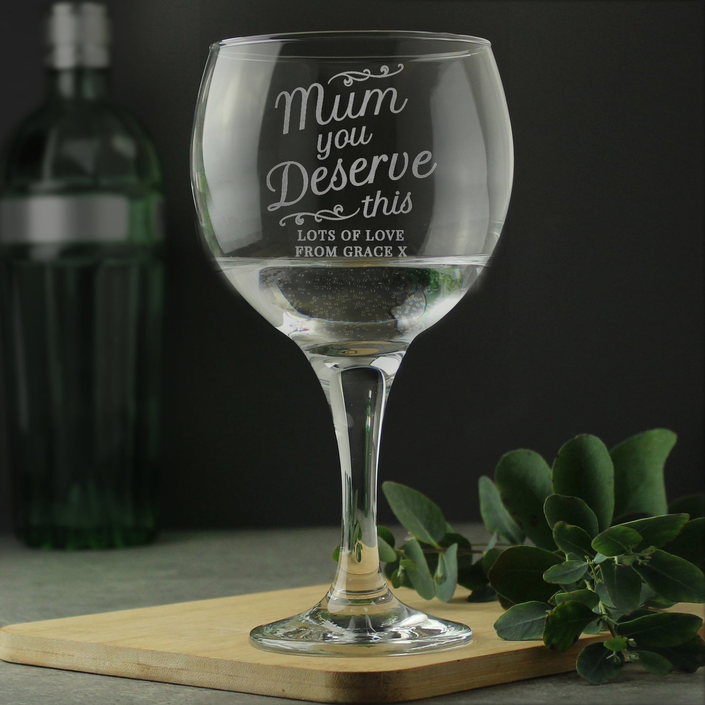 Personalised Wine glass with engraved message on a wooden board with a dark background