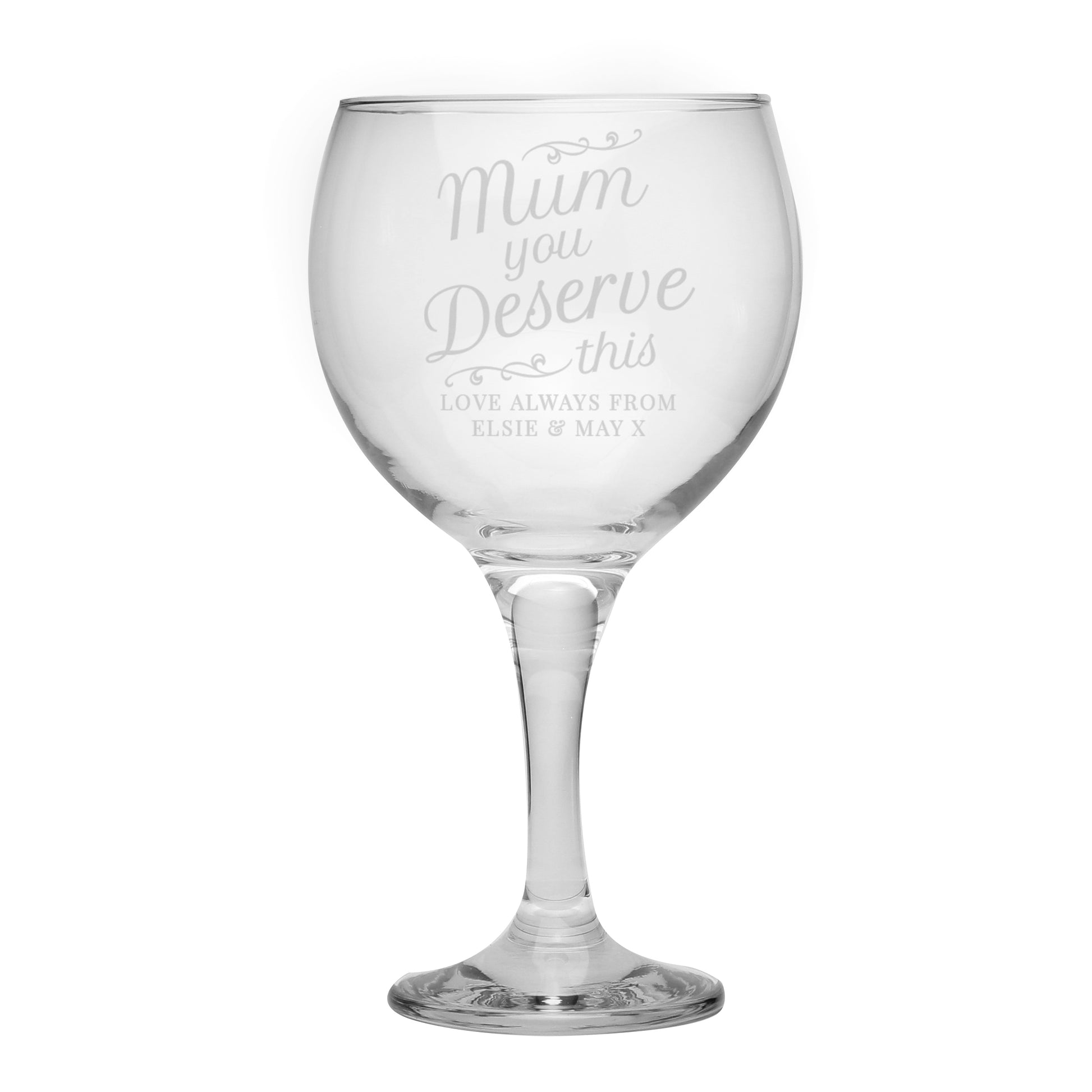 Clear wine glass with engraved text on a white background