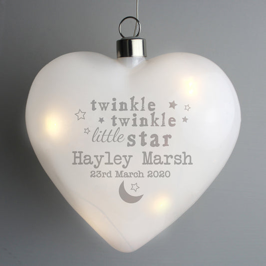 Heart-shaped light with engraved text on a gray background