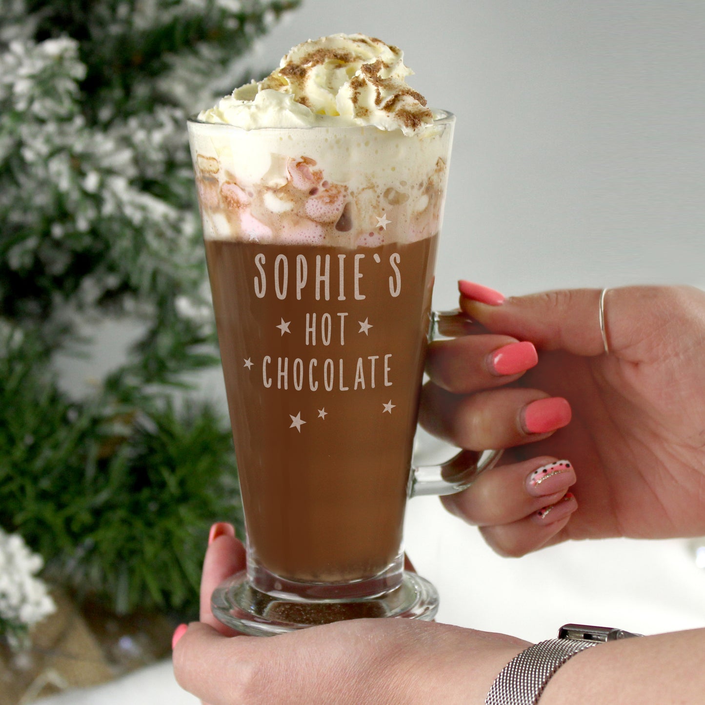 Hot chocolate with whipped cream held by a hand, featuring 'Sophie's Hot Chocolate' text.