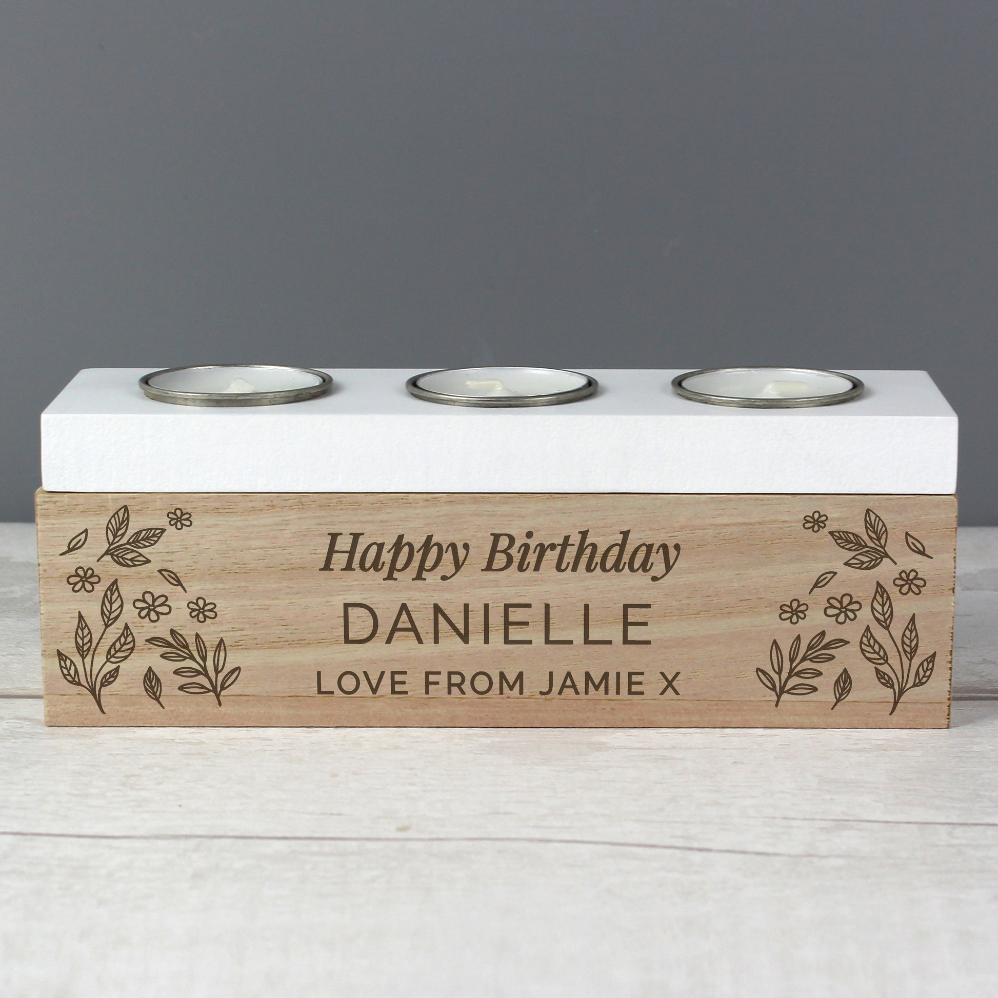Personalised birthday candle holder with engraved text on a wooden base