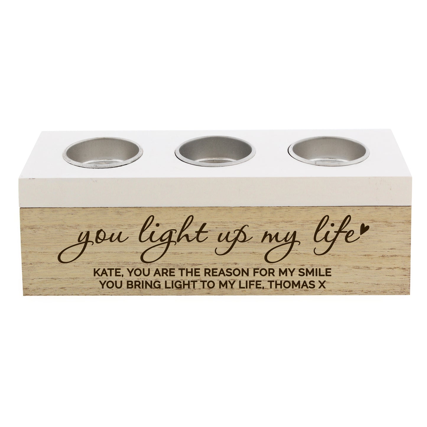 Three-socket candle holder with engraved message on a white background
