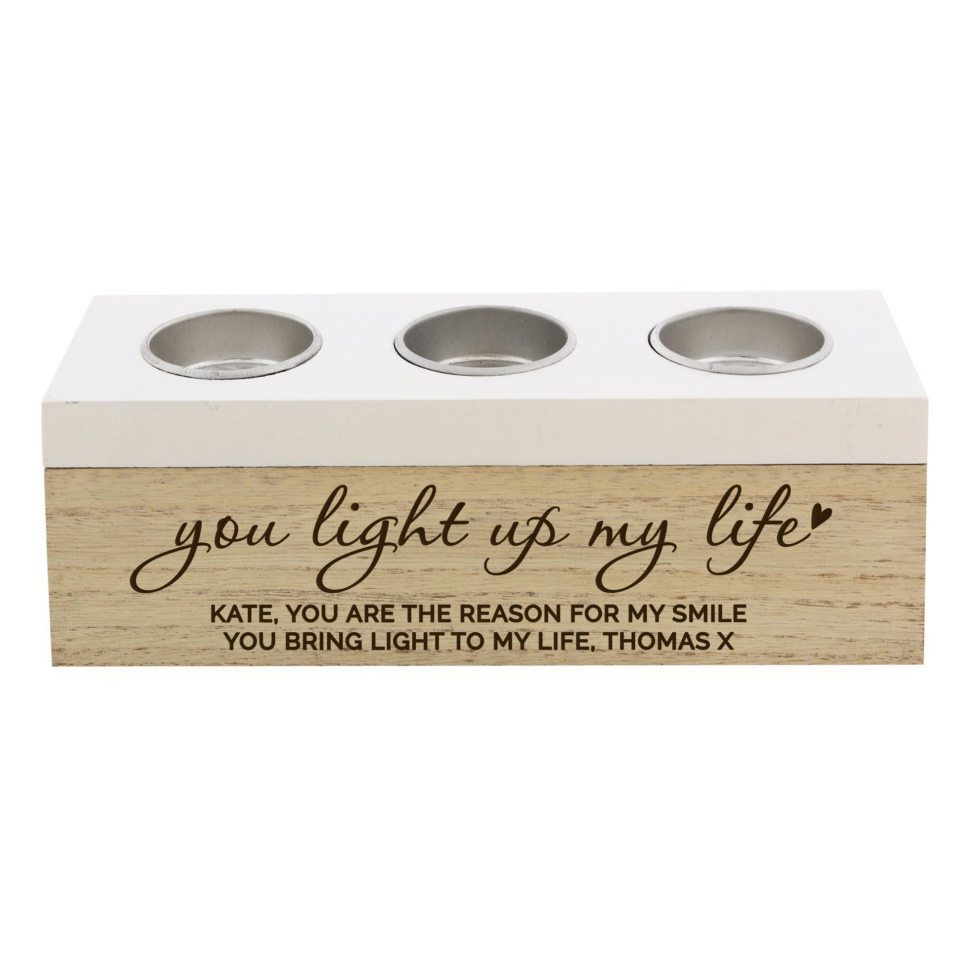 Three-socket candle holder with engraved message on a white background