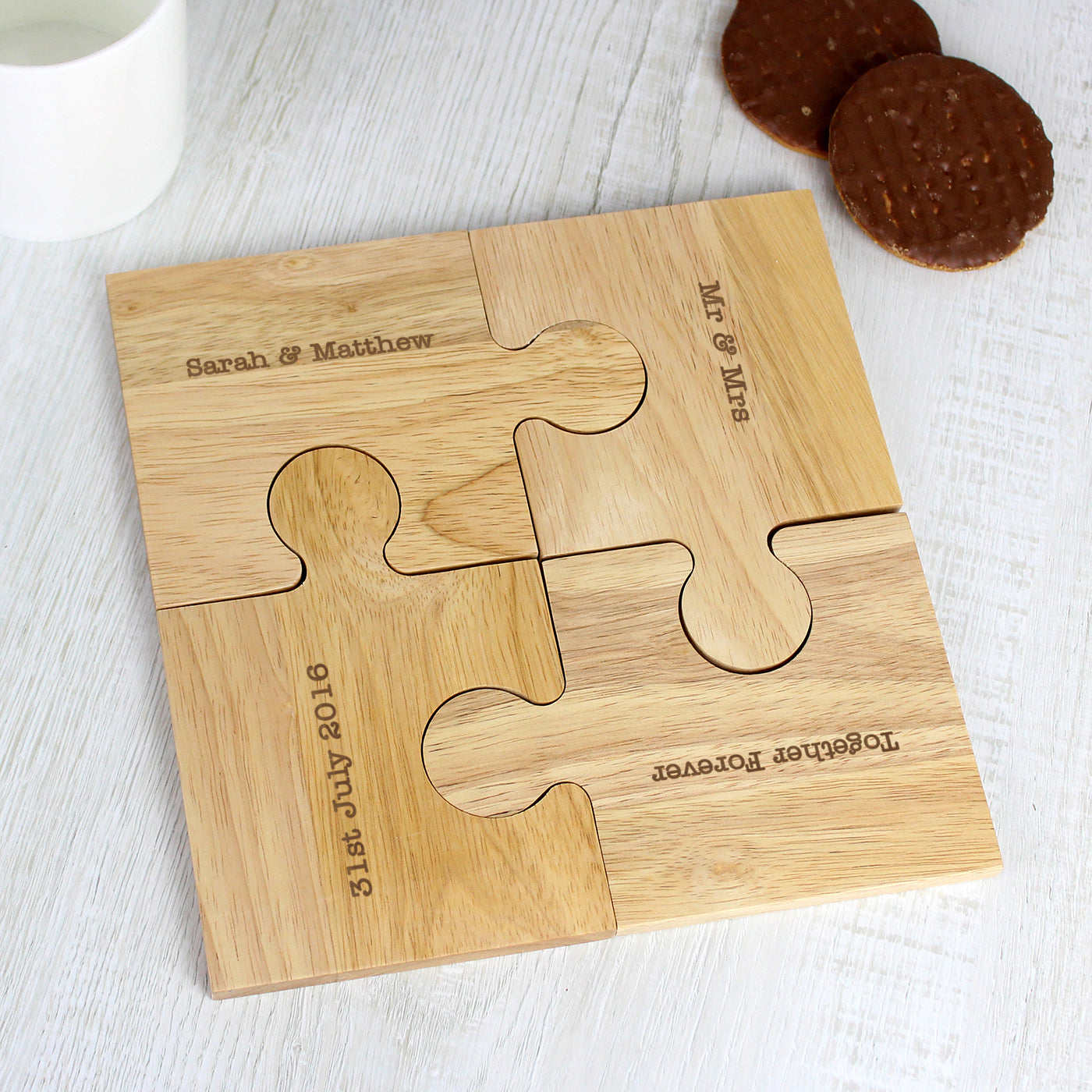 Wooden puzzle piece with engraved text on a white surface