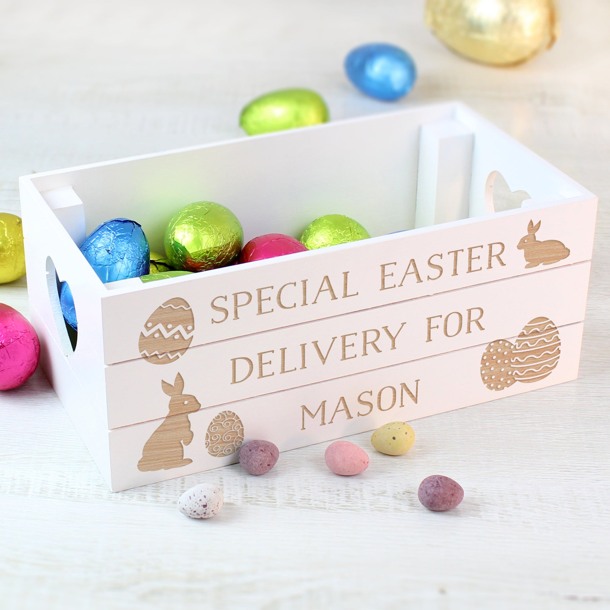 Wooden Easter basket with colorful eggs and 'Special Easter Delivery for Mason' text on a light background.