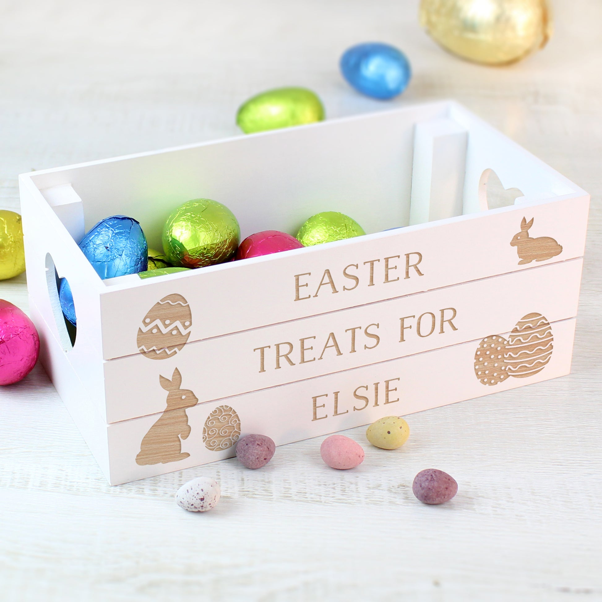 Wooden Easter basket with personalised name and colourful eggs on a light background