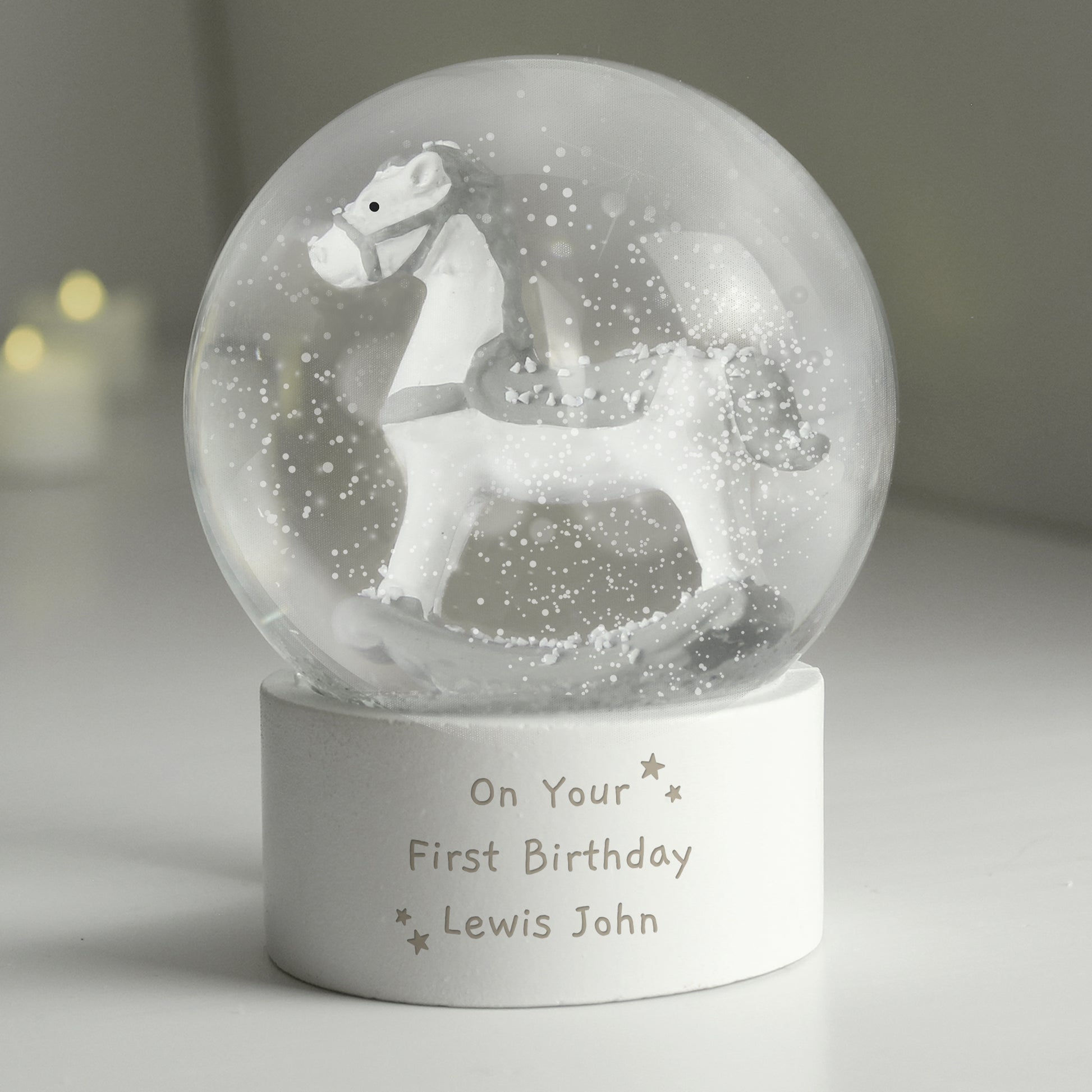 Personalised snow globe with a horse figure and engraved text on a neutral background
