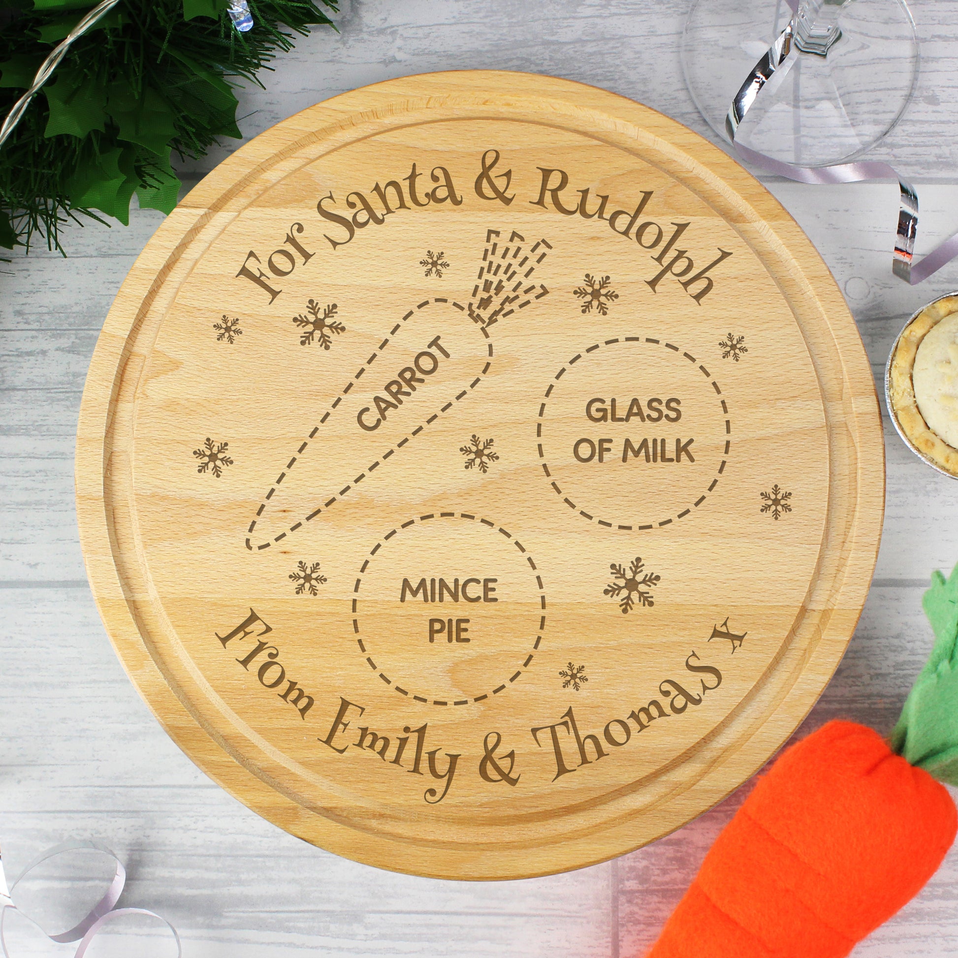 Wooden cutting board with engraved text for Santa and Rudolph, featuring a carrot, glass of milk, and mince pie.