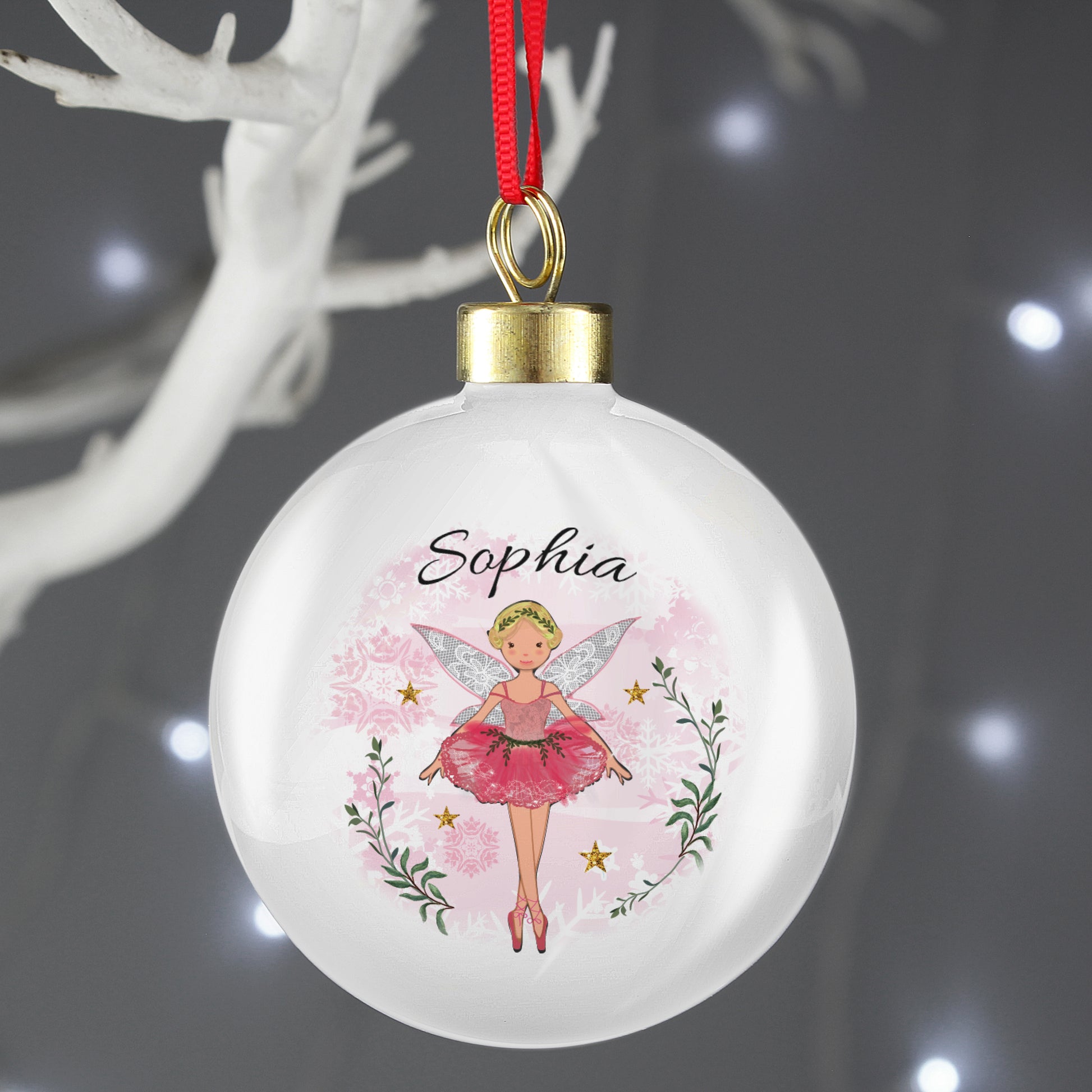 Decorative Christmas ball ornament with a fairy design and the name 'Sophia' on a dark background.