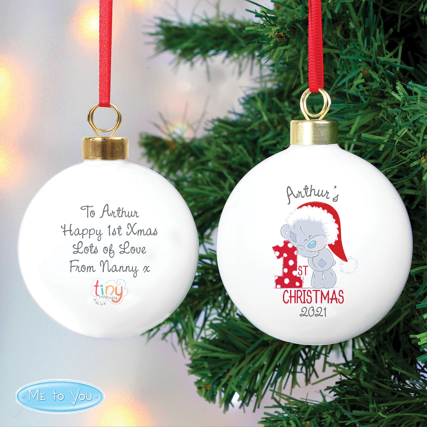 Christmas ornament with text and a teddy bear design on a tree.