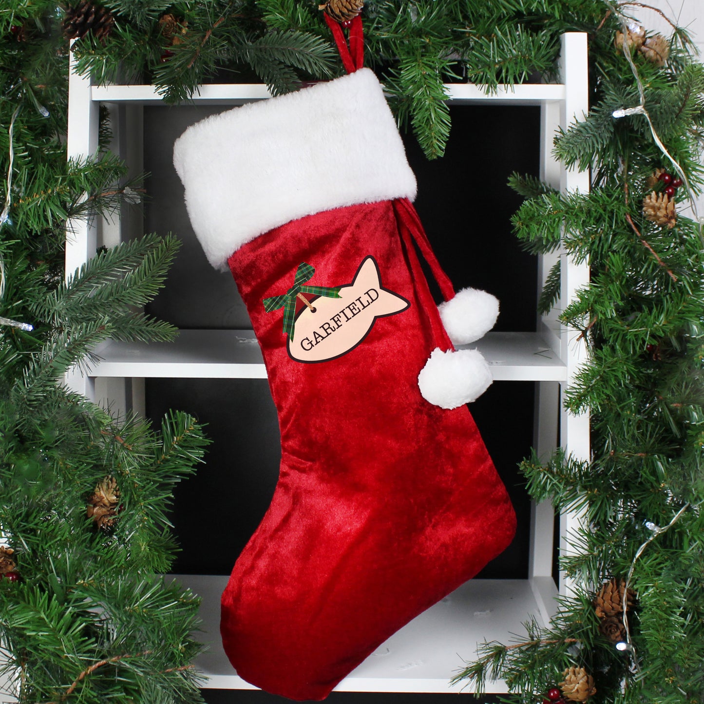 Red Christmas stocking with Garfield design hanging on a tree