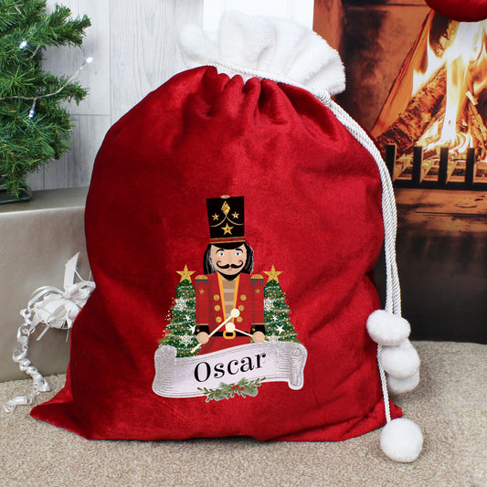 Personalised Red Christmas sack with Nutcracker design and 'Oscar' text, placed against a festive background.