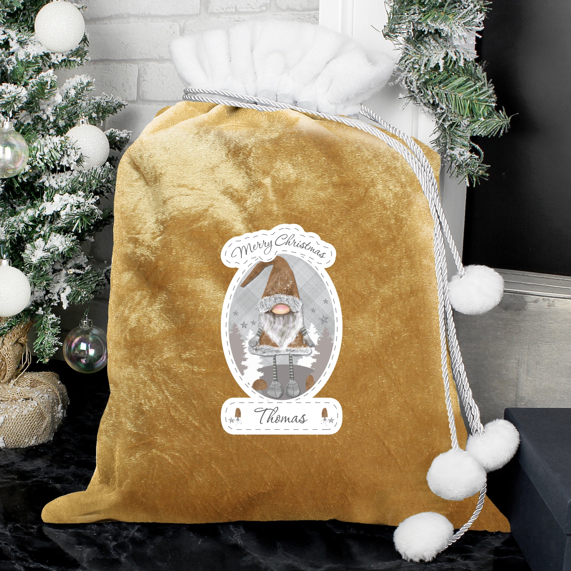 Personalised Gold velvet drawstring bag with Christmas-themed design and tree in the background