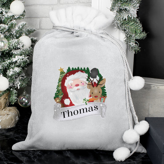 Personalised Christmas sack with Santa and reindeer design, decorated with white pom-poms, against a festive background.