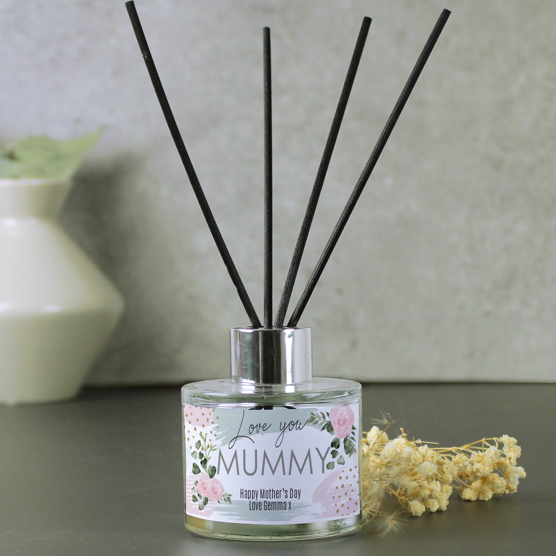 Reed diffuser with 'Love you Mummy' label on a neutral background