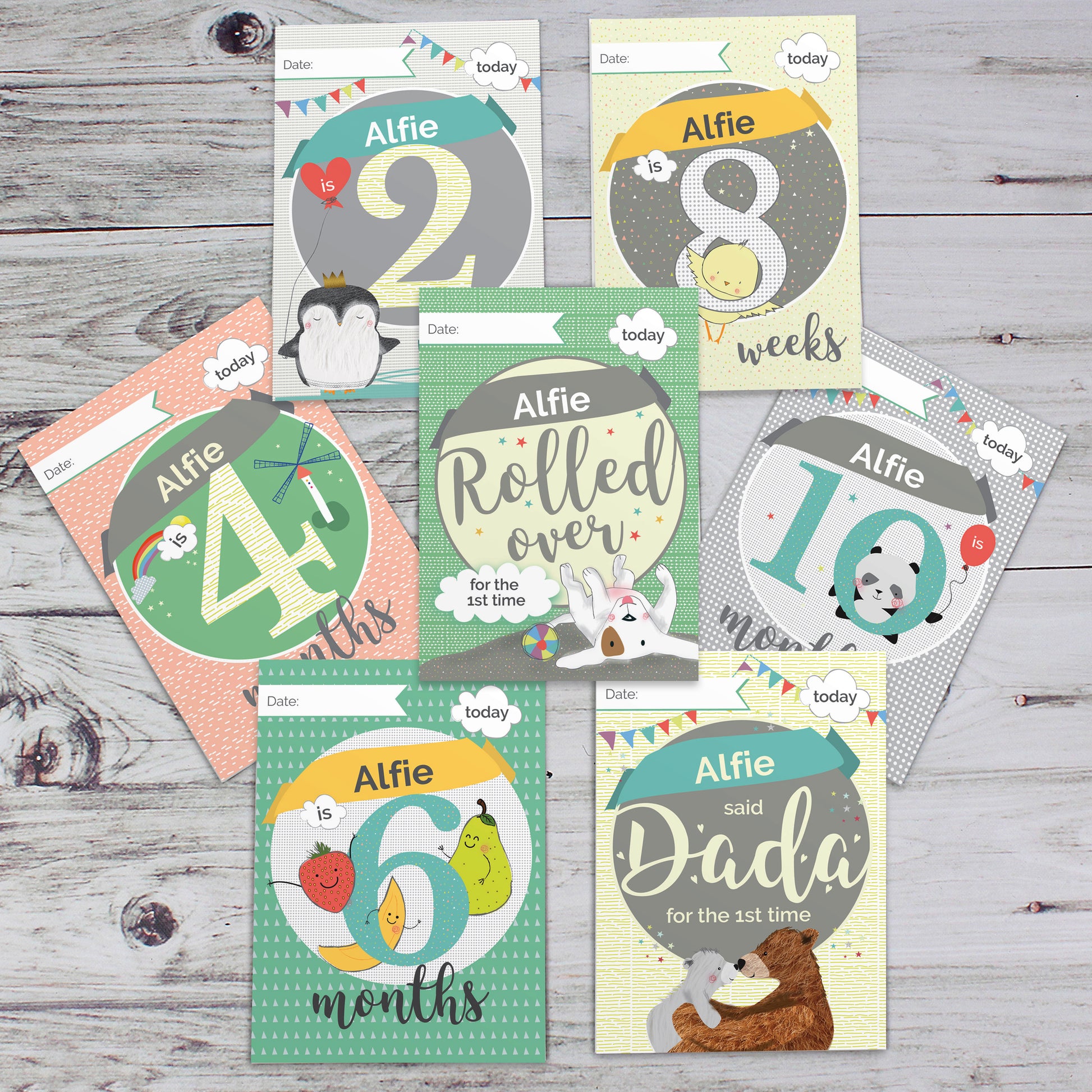 Collection of baby milestone cards on a wooden surface