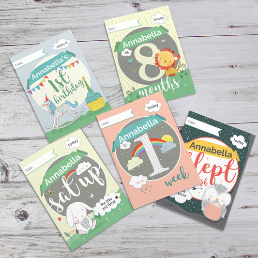 Personalised Collection of milestone cards for a baby named Annabella on a wooden surface