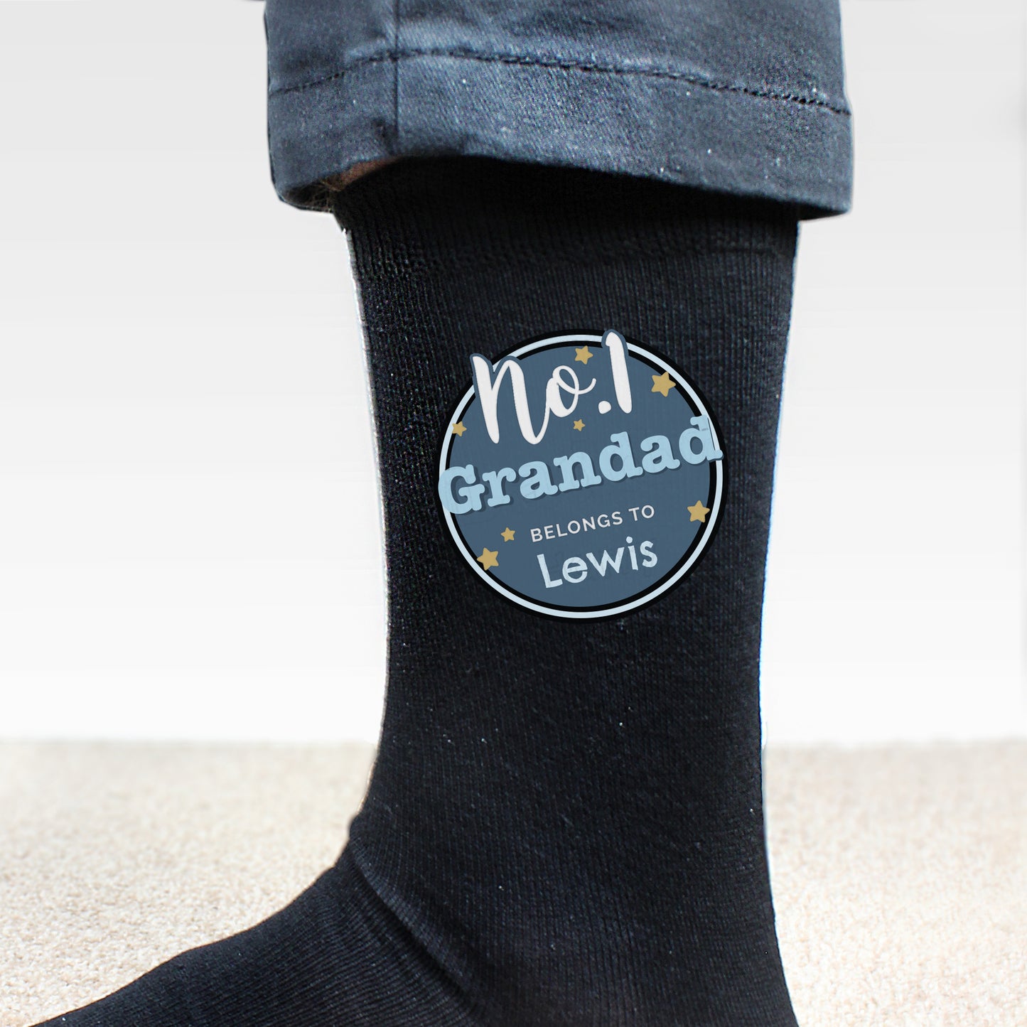 Black sock with a personalised label on a white background