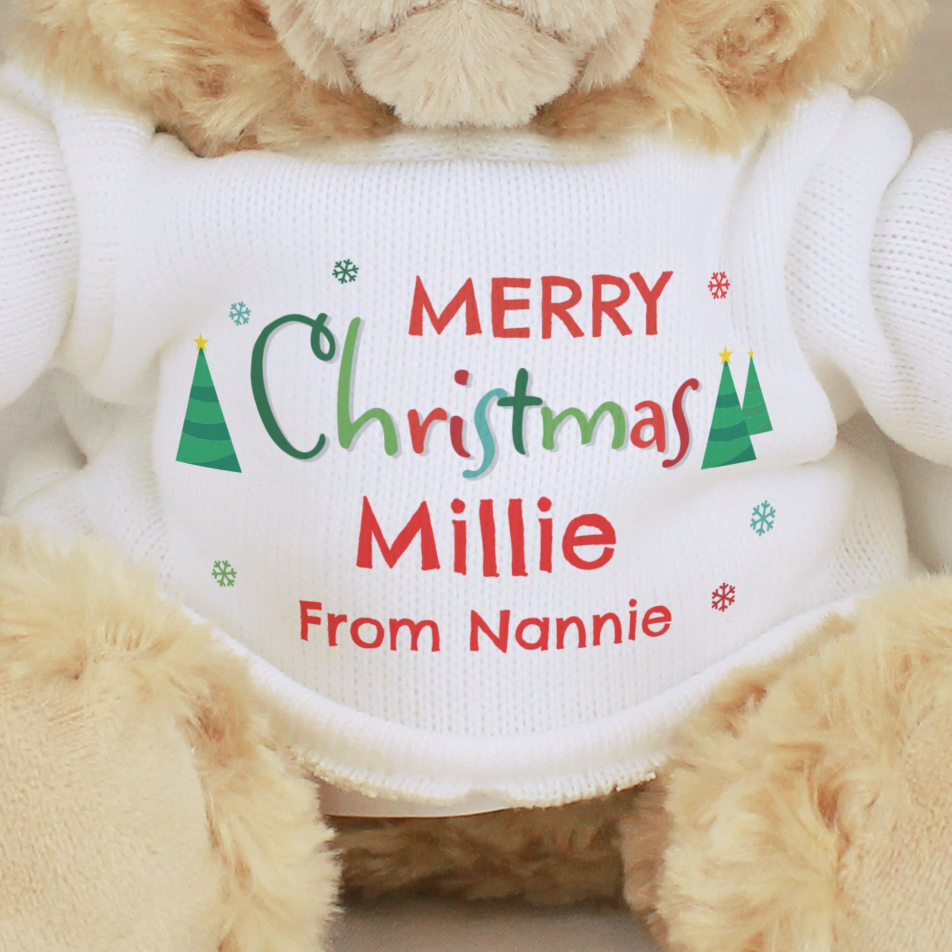 Teddy bear wearing a Christmas-themed sweater with personalised text