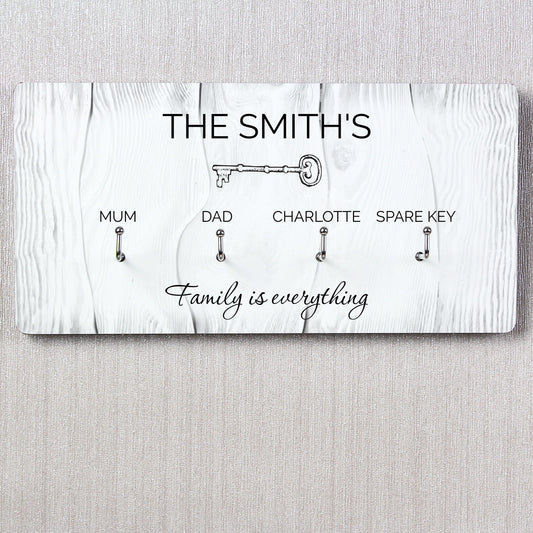 Personalised Key holder with keys for 'Mum', 'Dad', 'Charlotte', and 'Spare Key' on a white wooden background.
